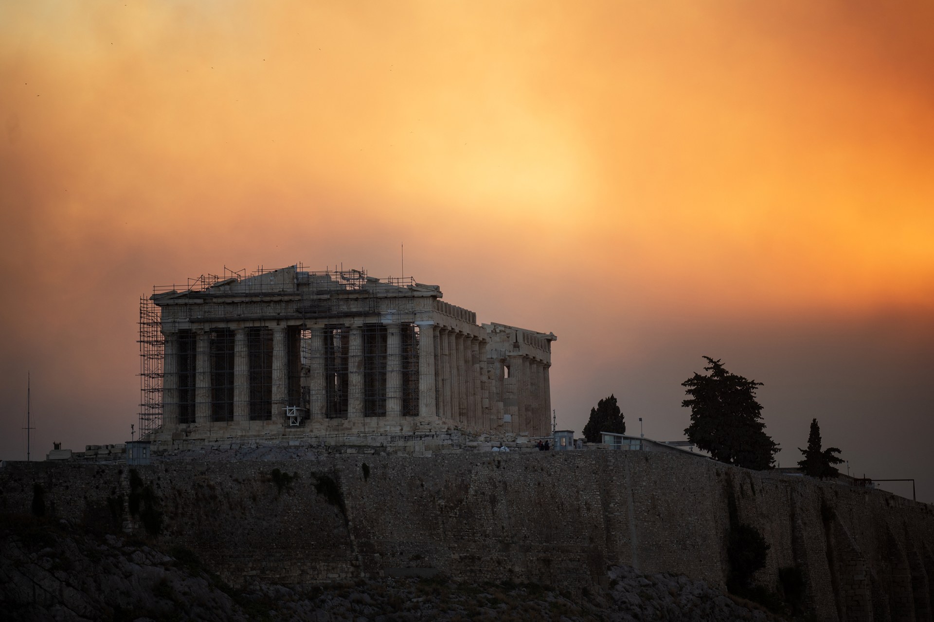 View of the Parthenon temple in Athens atop the Acropolis hill in a smoke cloud from wildfires.