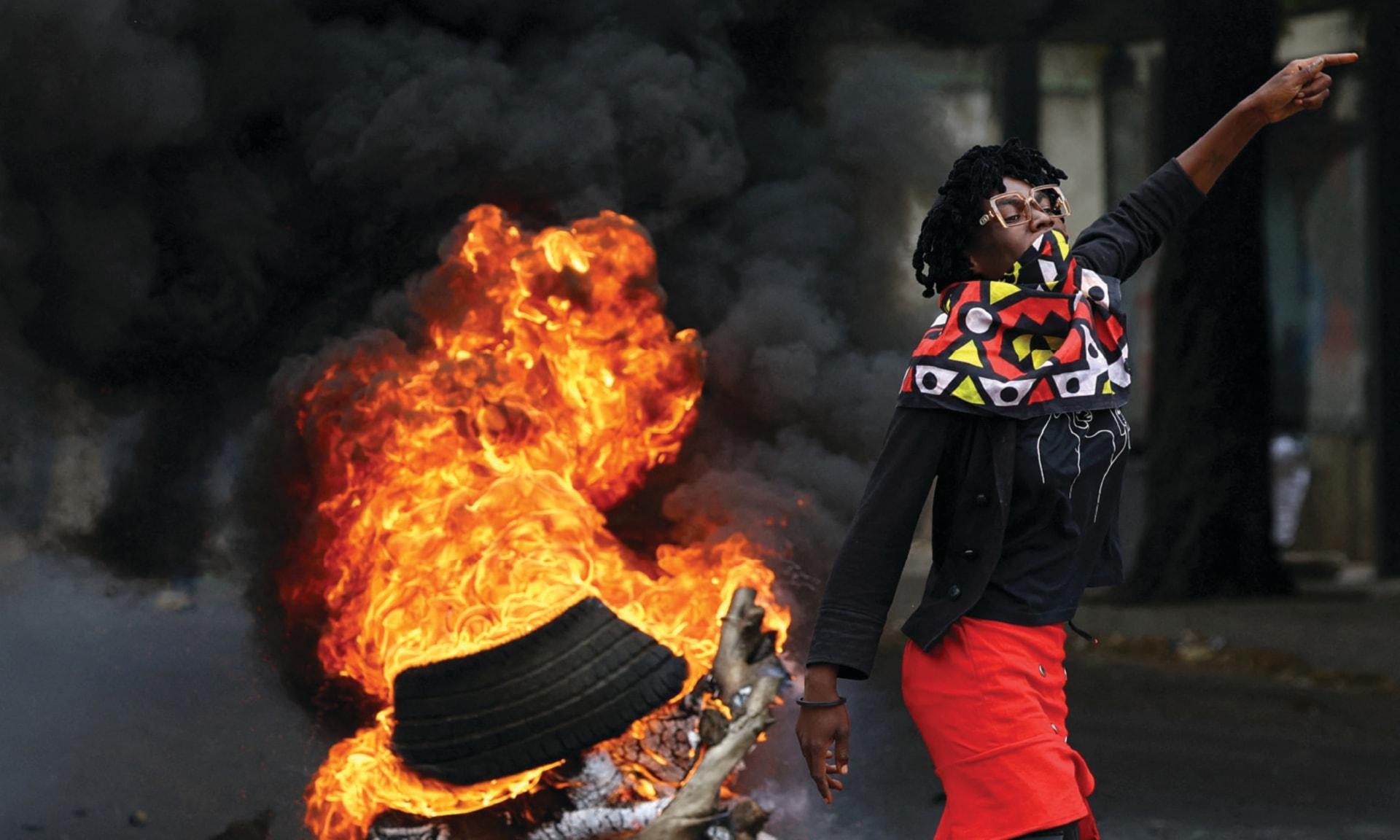 A protester reacts near a burning barricade during a ”national shutdown” against the recent election outcome, at Luis Cabral township in Maputo, Mozambique, on November 7, 2024.