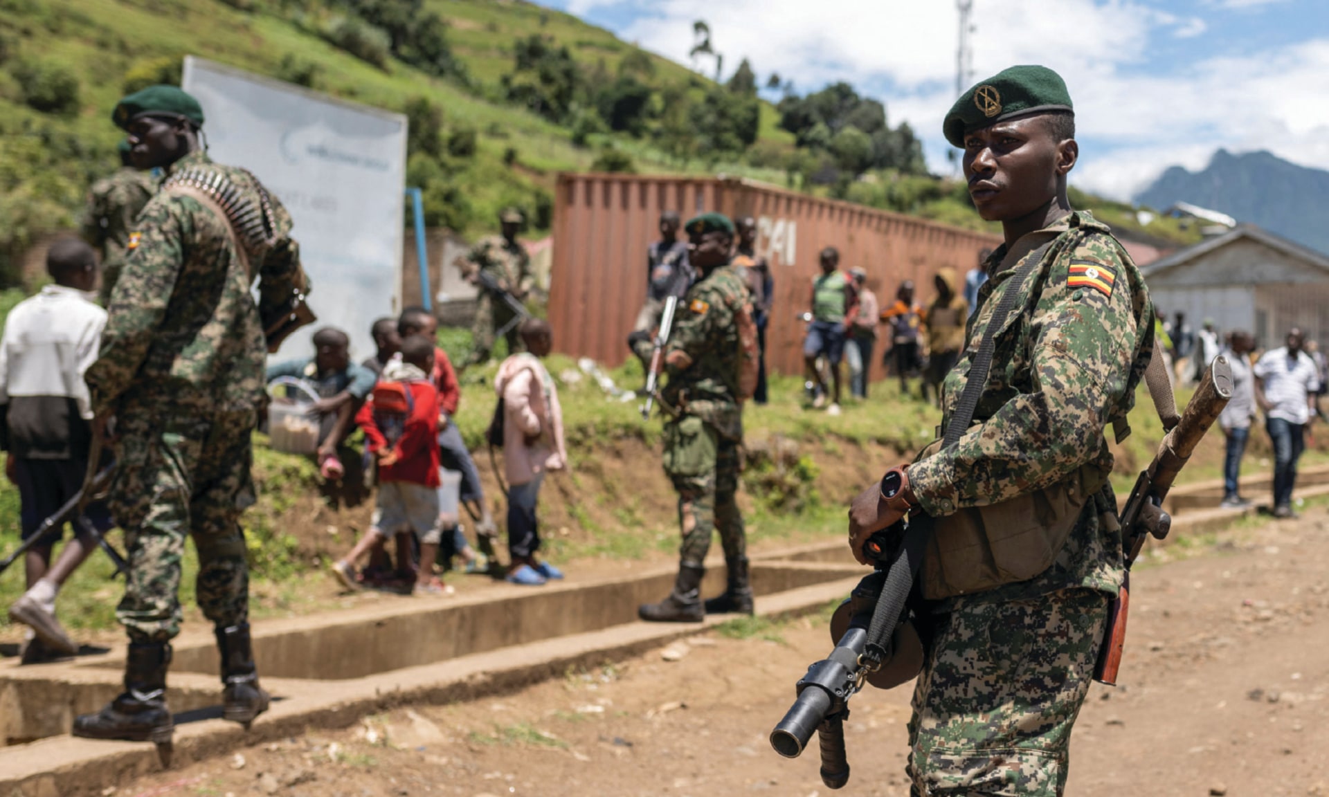 Members of the Ugandan army stand in a formation as they patrol a settlement ceded by M23 rebels fighters to EACRF soldiers in the North Kivu province of the Democratic Republic of Congo.