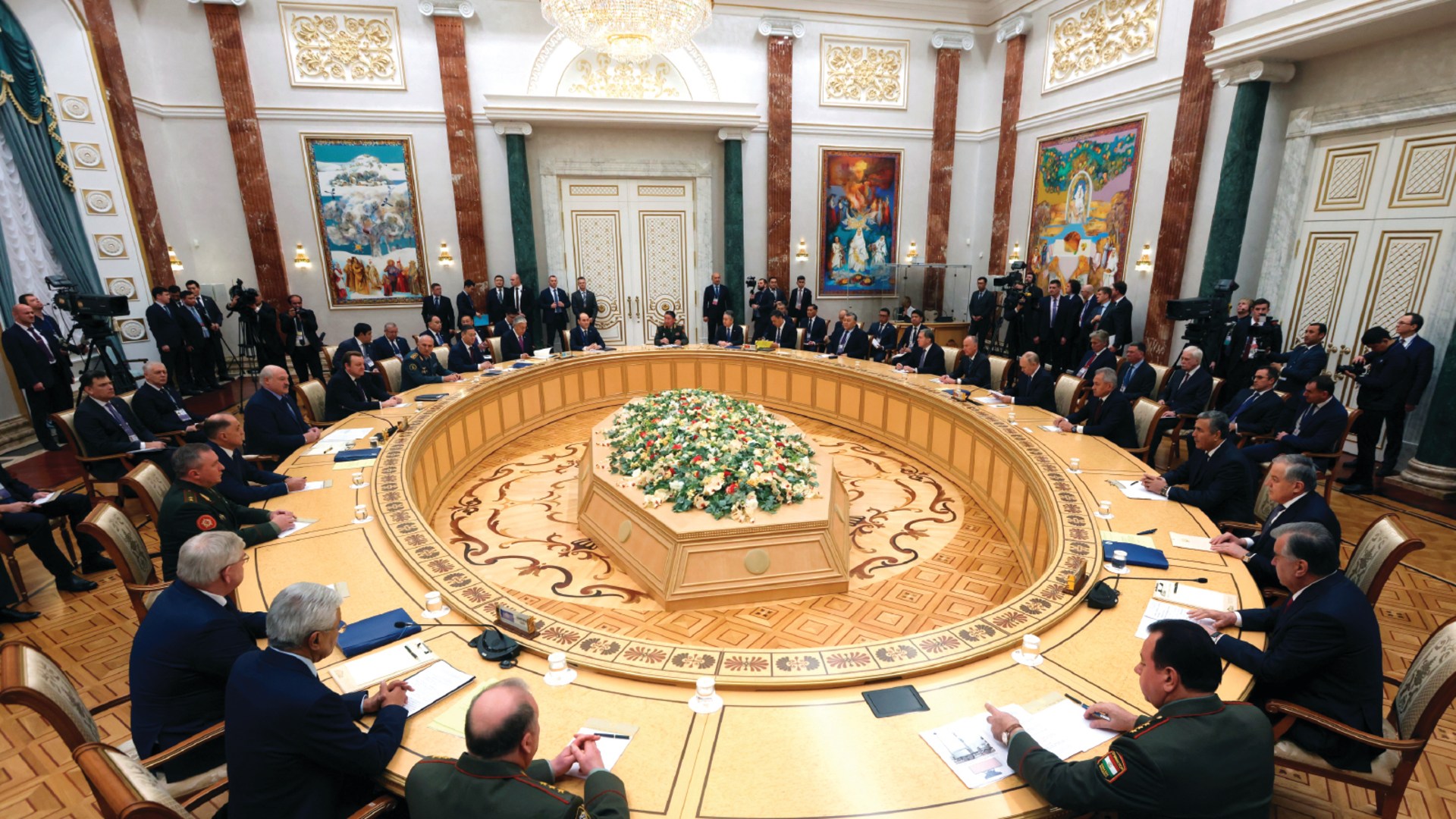 Heads of state and delegation members sit around a round table while attending the Collective Security Treaty Organization (CSTO) summit in Minsk, Belarus.