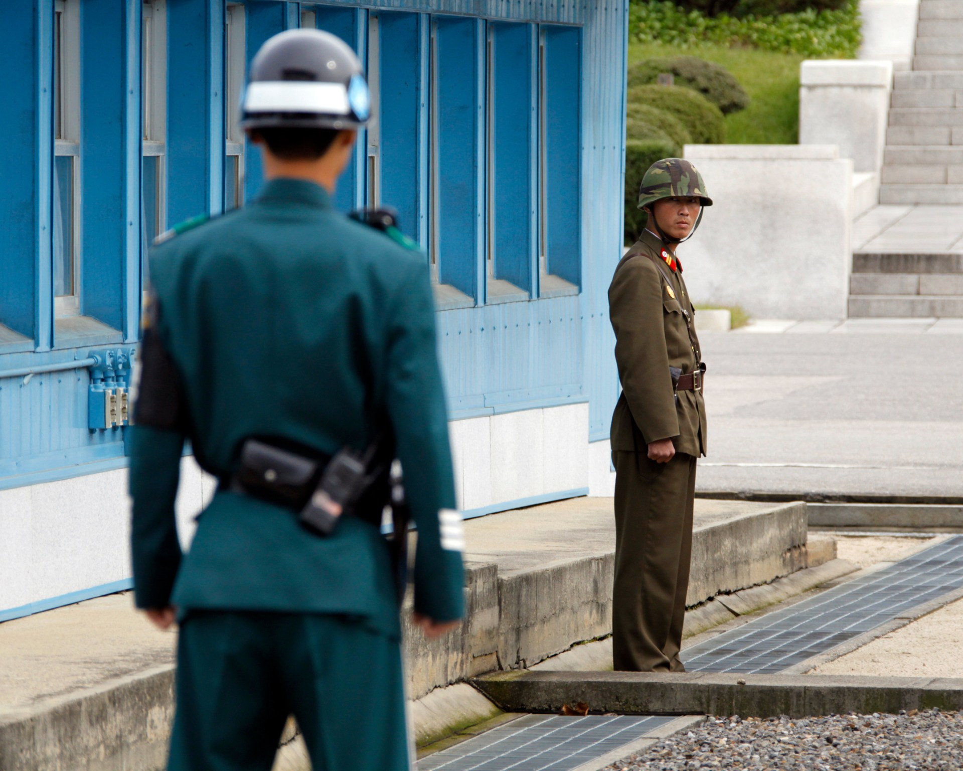 A North Korean soldier stares at a South Korean soldier across the concrete border separating the two Koreas in the demilitarized zone.