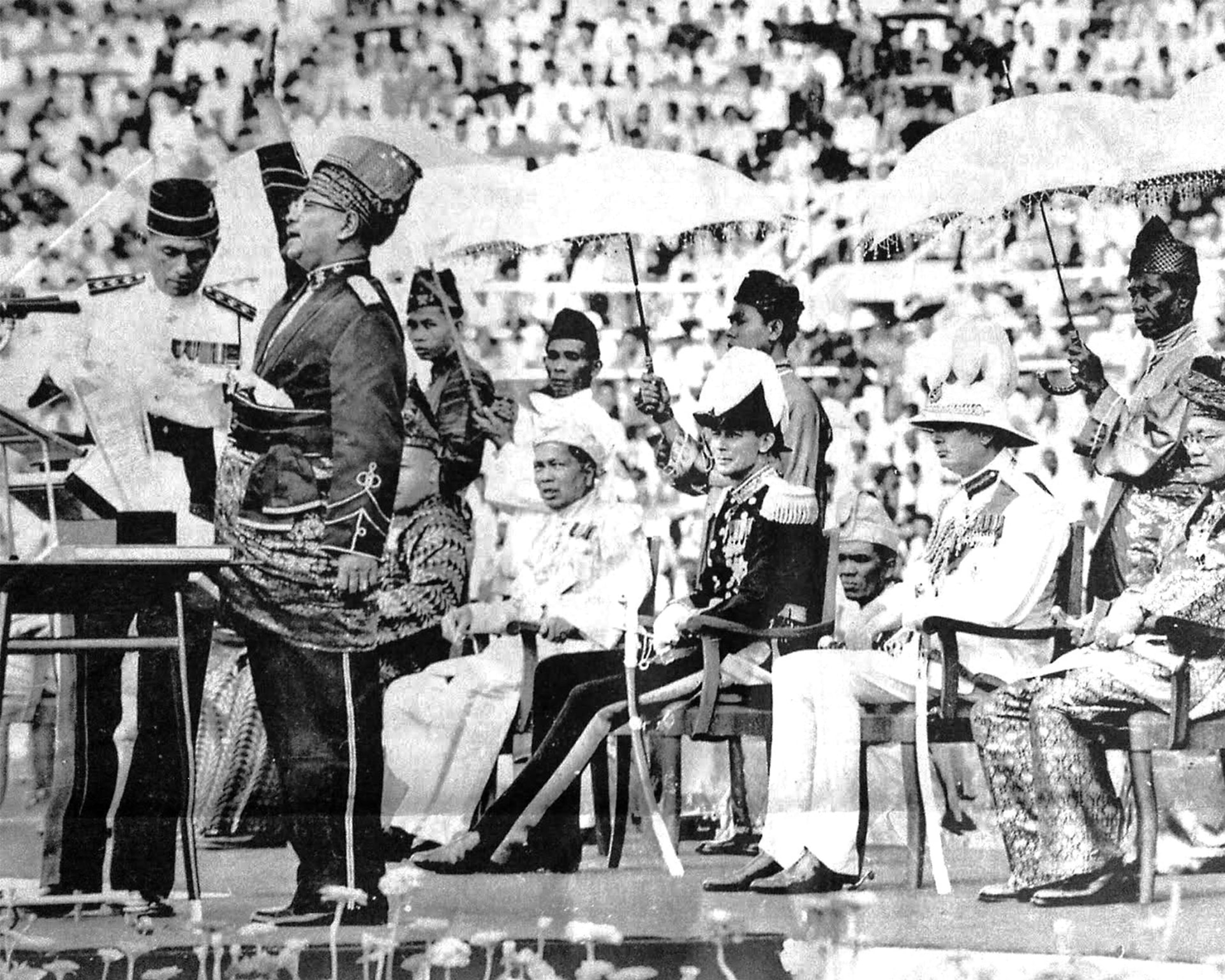 Malaysia's First Prime Minister, Tunku Abdul Rahman, raises his right hand as he reads the Proclamation of Independence in Kuala Lumpur, Malaysia.