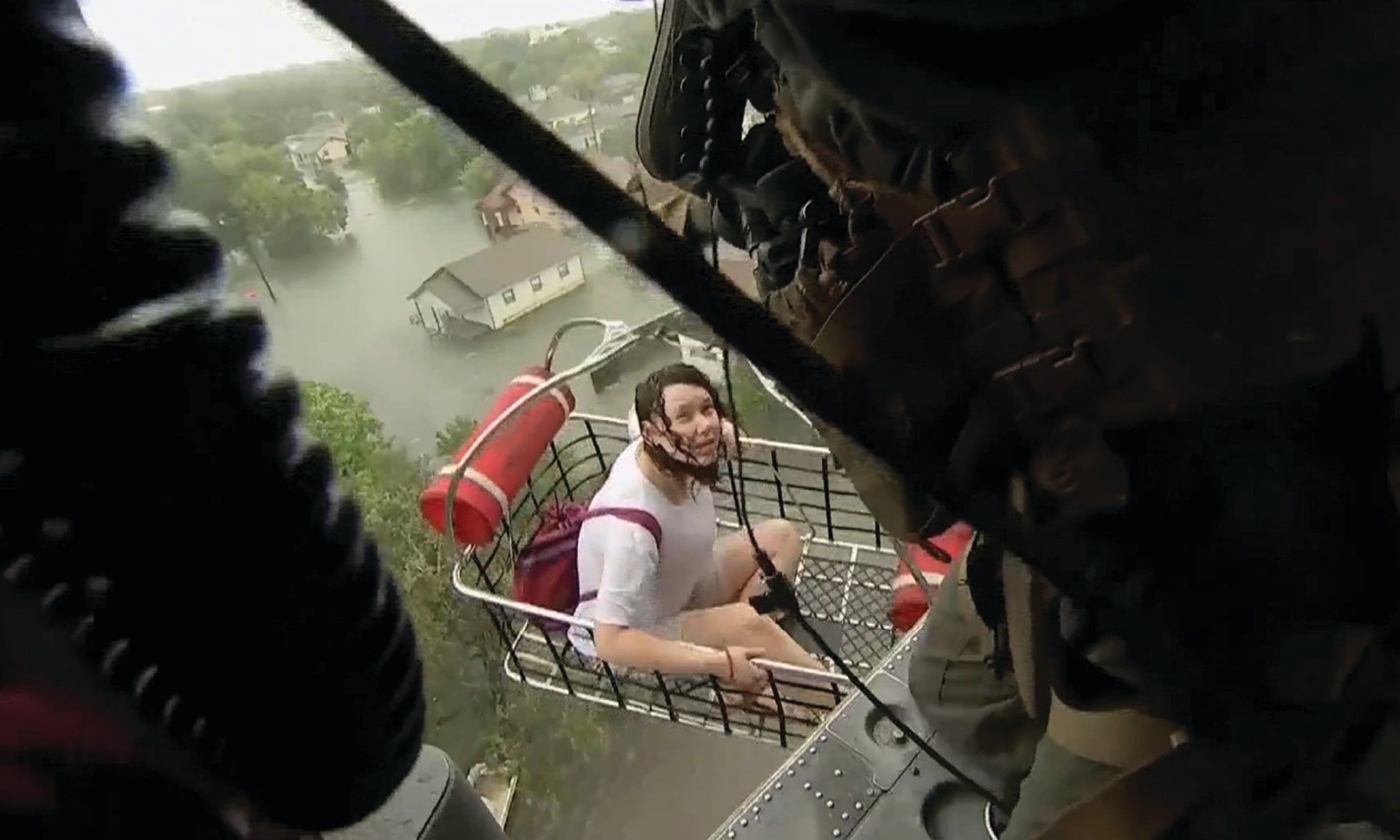 A woman is rescued from Tropical Storm Harvey flood waters by a U.S. Navy Helicopter in Beaumont, Texas, U.S on August 30, 2017.