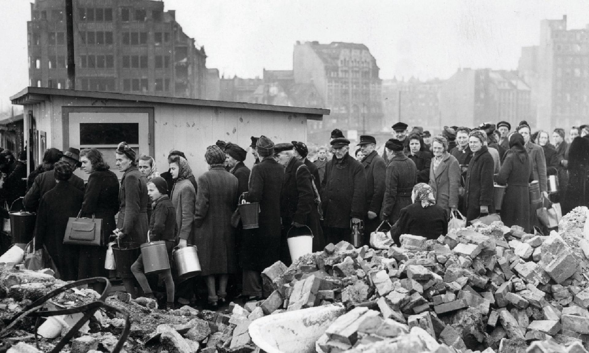 Citizens of Hamburg, Germany line up among the city's ruins for soup rations on March 26, 1946.