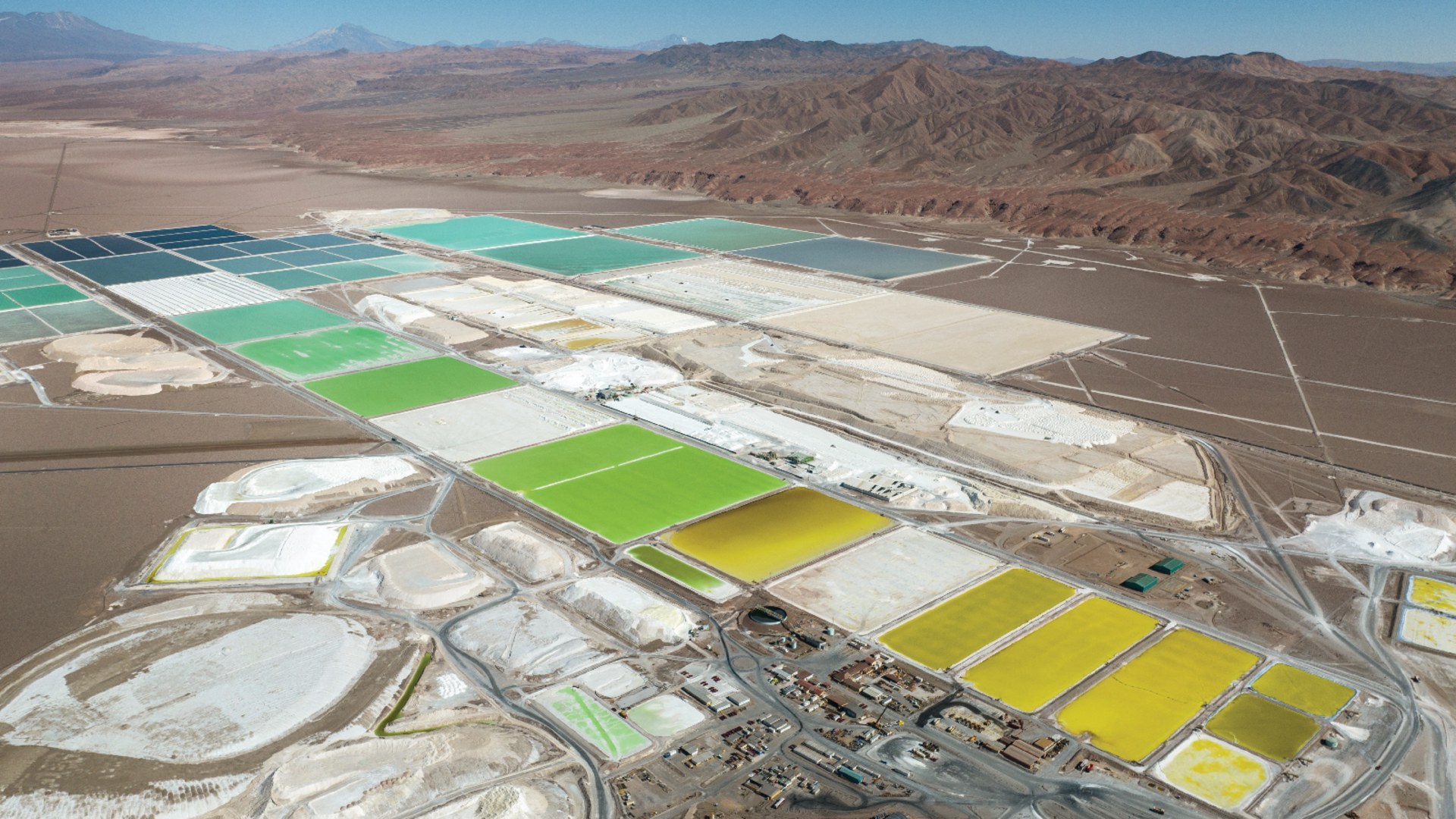 An aerial view of pools of brine containing lithium carbonate and mounds of salt by-product in a lithium mine in Salar de Atacama, Chile, on August 24, 2022.