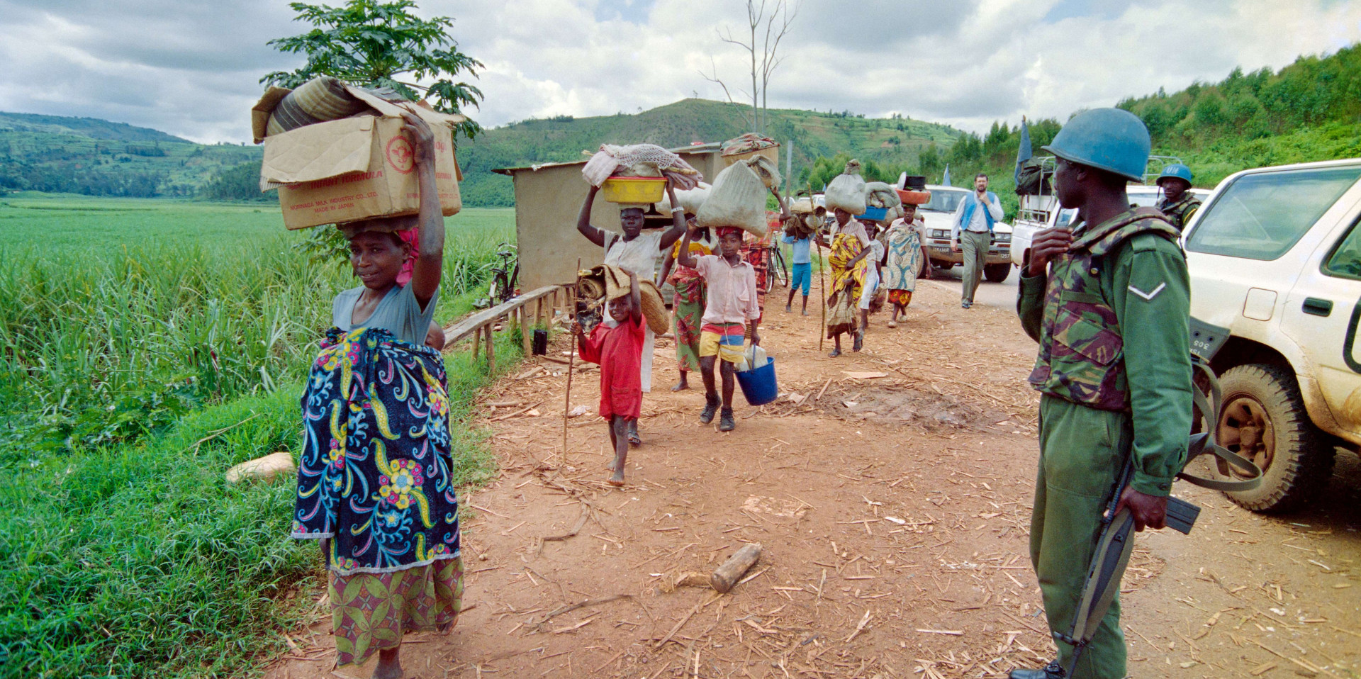 Rwandan refugees walk on the Byumba road as they flee from Kigali on May 11, 1994.
