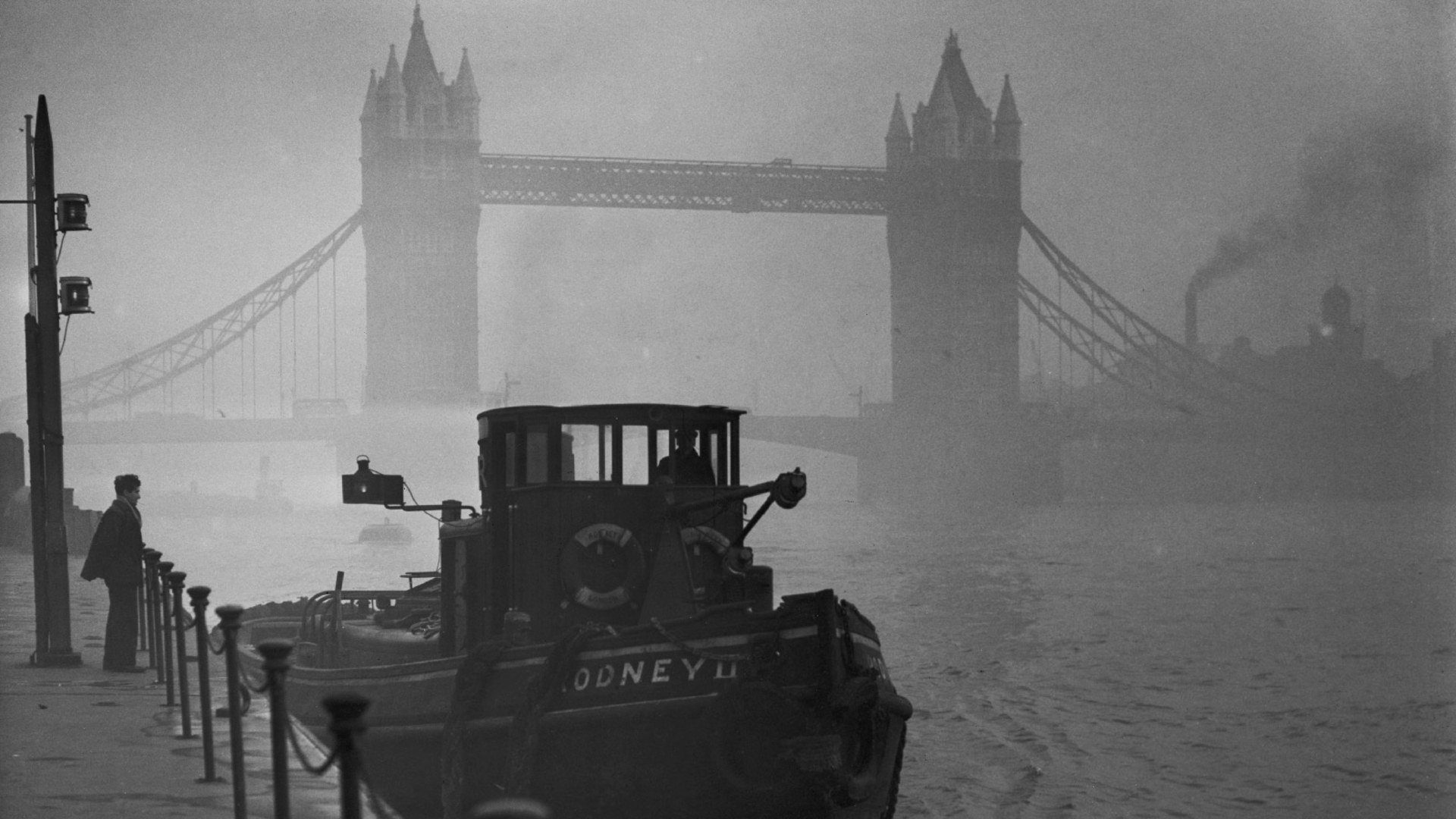 A docked tugboat enveloped in thick smog on the River Thames, in London, England on January 1st 1952.