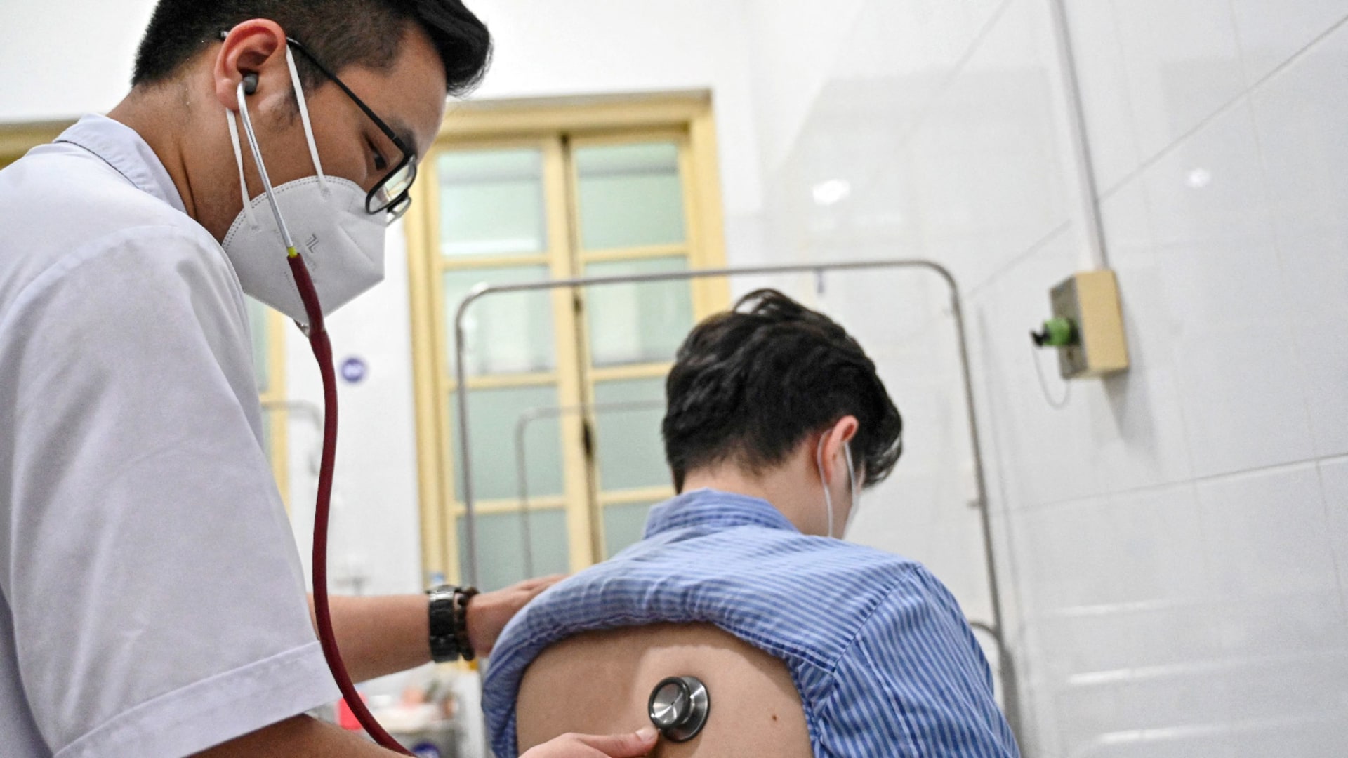 Doctor checks tuberculosis patient in Hanoi, Vietnam on April 2, 2024.