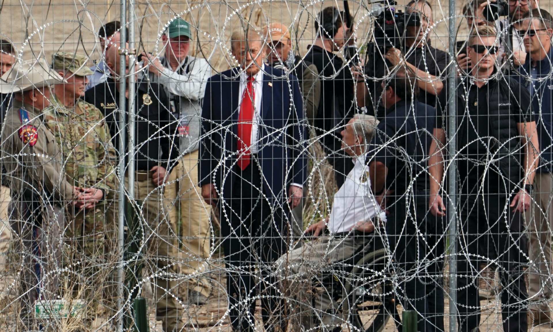 U.S. President Donald Trump speaks with Texas Governor Greg Abbott during a visit at the U.S.-Mexico border at Eagle Pass, Texas, as seen from Piedras Negras, Mexico, February 29, 2024. 