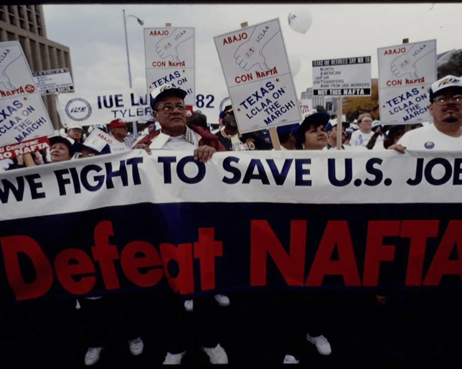 Demonstrators hold a banner reading ”We fight to save U.S. jobs” at a demonstration against NAFTA.