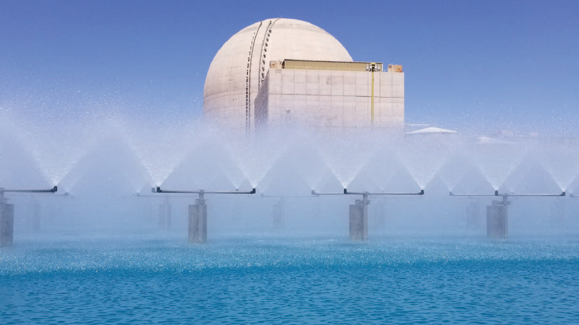 A spray pond at a nuclear plant helping to cool down the structure. Large sprinklers spray water all around.
