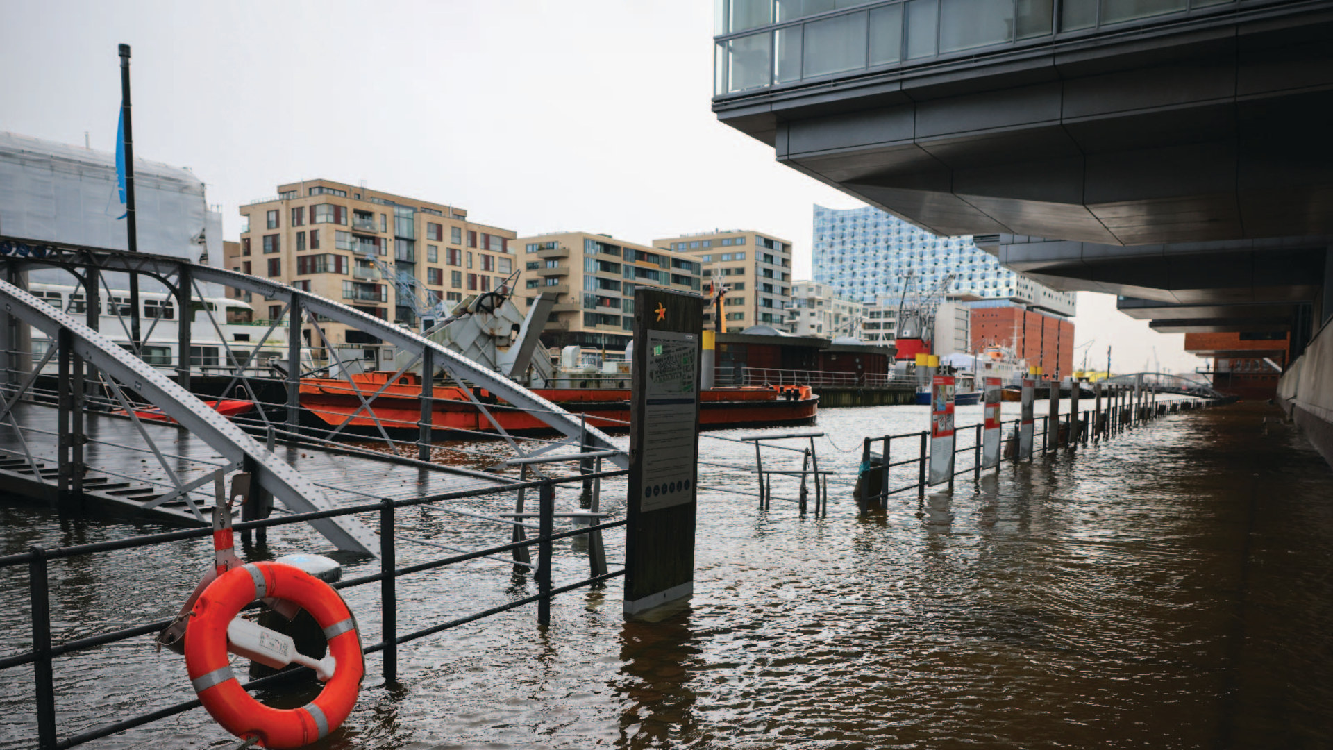 Water floods the promenade at a ship harbor in Hamburg, Germany