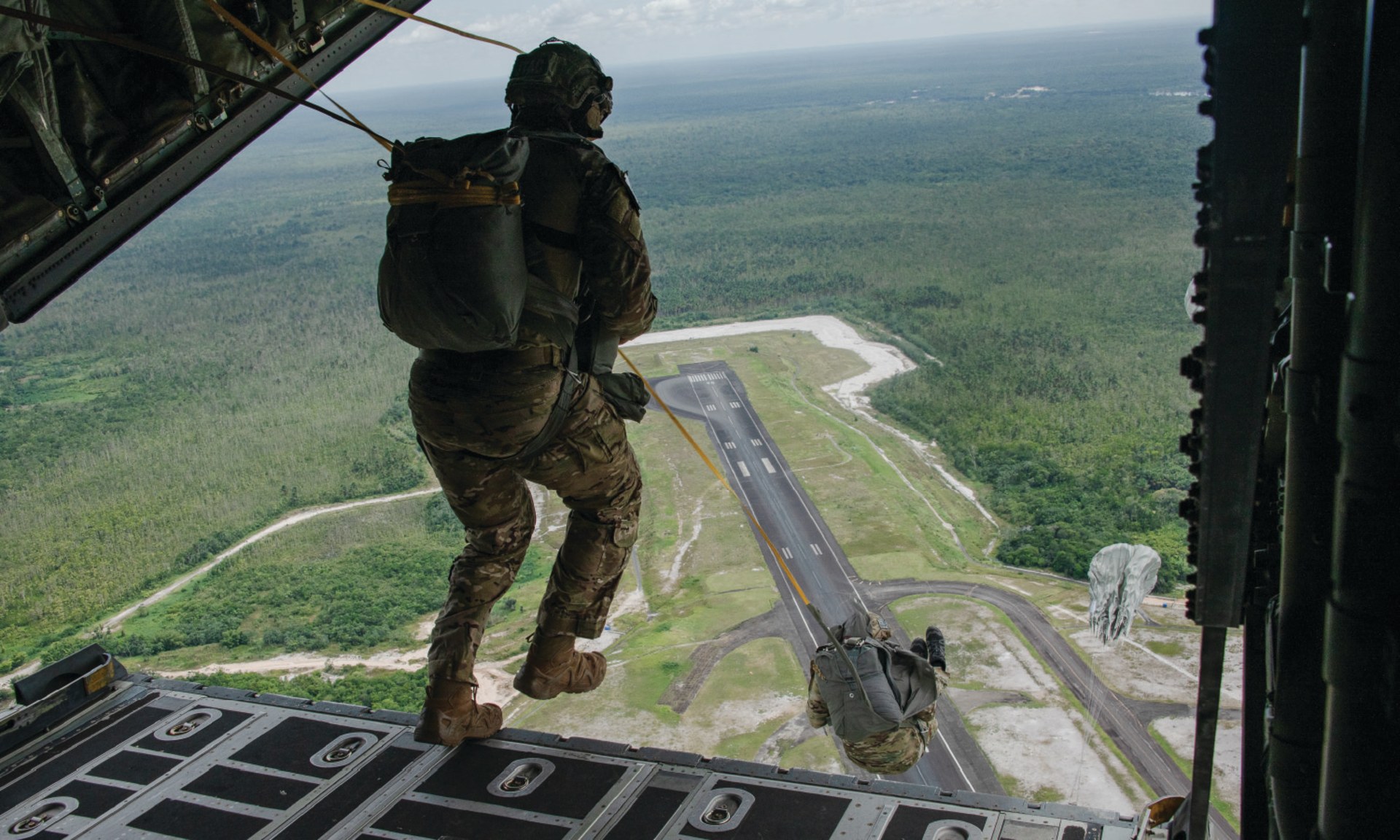 Tactical Air Control Party specialists with the 137th Special Operations Wing, Oklahoma National Guard, conduct a static line jump during an exercise over Air Base London, Guyana, on July 18, 2023.