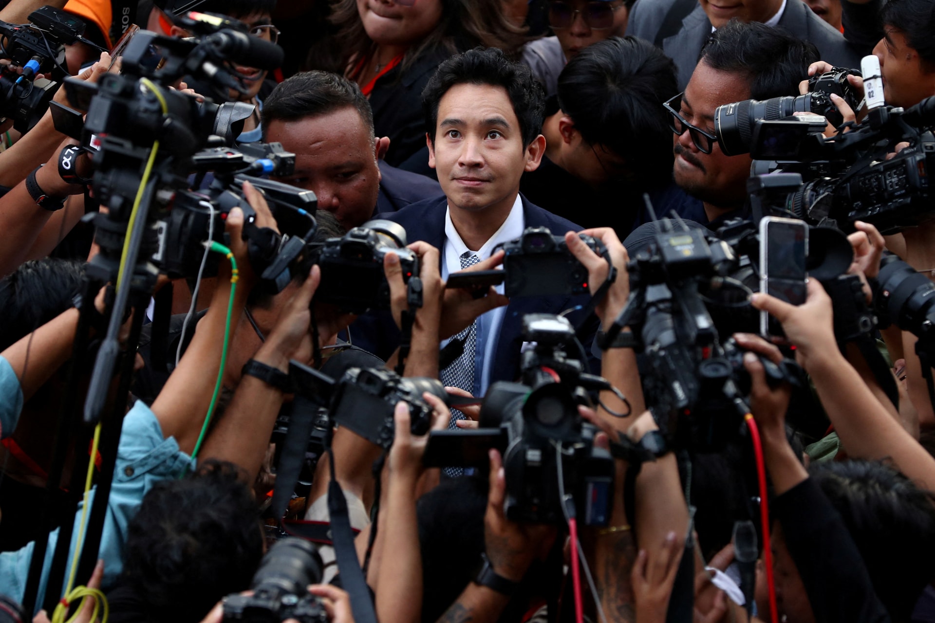 Former Move Forward party leader Pita Limjaroenrat looks on as he arrives at the party headquarters after Thailand's Constitutional Court delivered a verdict on a case seeking the dissolution of the opposition group over its call for lese-majeste reform.