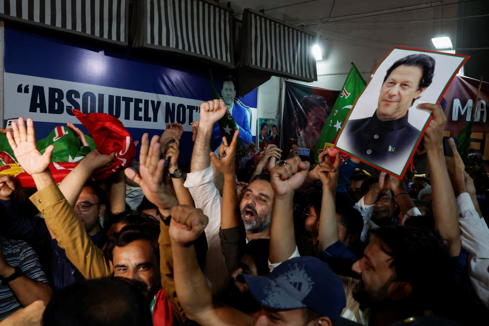 Supporters of former Prime Minister Imran Khan's party, the Pakistan Tehreek-e-Insaf (PTI), chant slogans to celebrate after a high court overturned jailed former Prime Minister Imran Khan's conviction on charges of leaking state secrets.