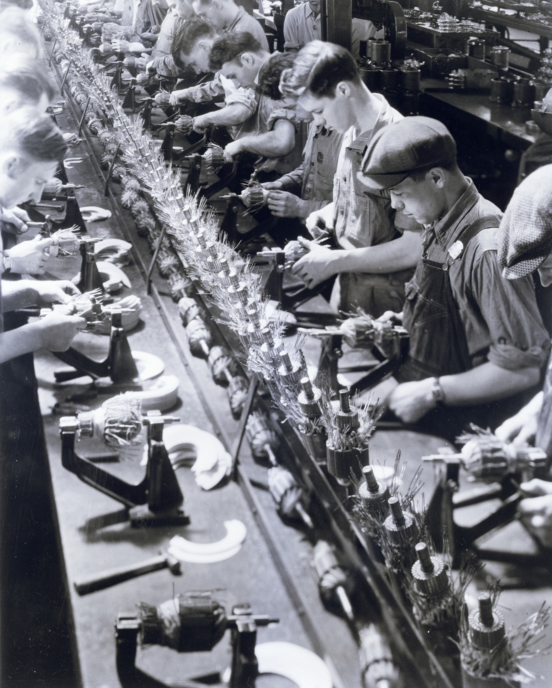 Men on an assembly line work on Ford generators in a small plant at Ypsilanti, Michigan, about 2.5 miles from Dearborn.