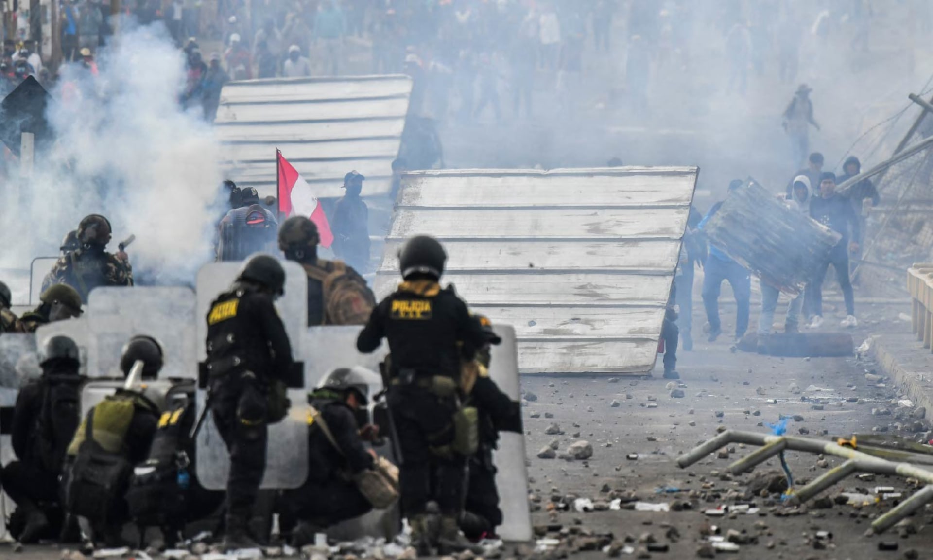 Smoke fills the air as demonstrators clash with riot police at the Añashuayco bridge in Arequipa, Peru.