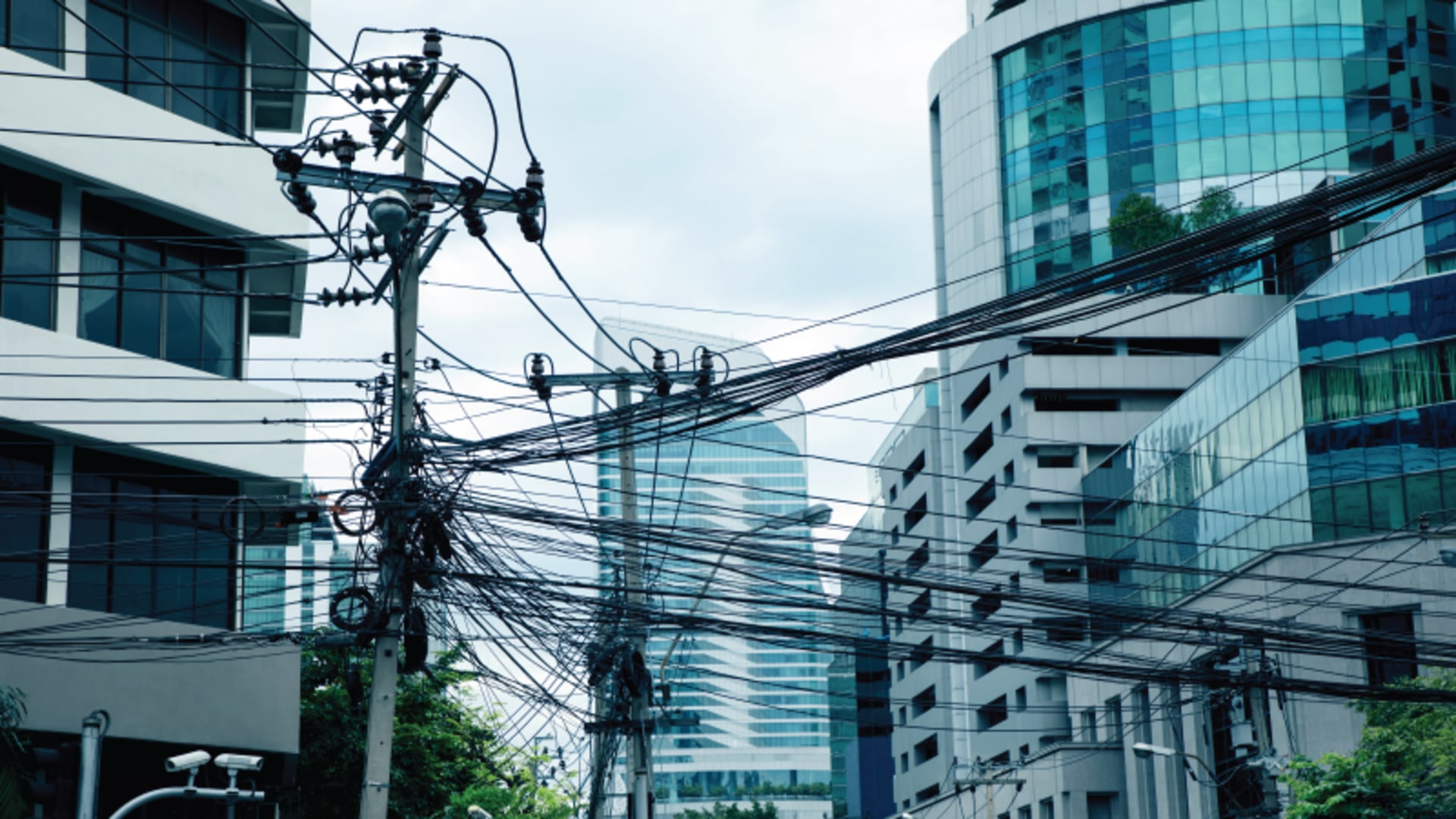 Power lines amidst buildings in Bangkok, Thailand.