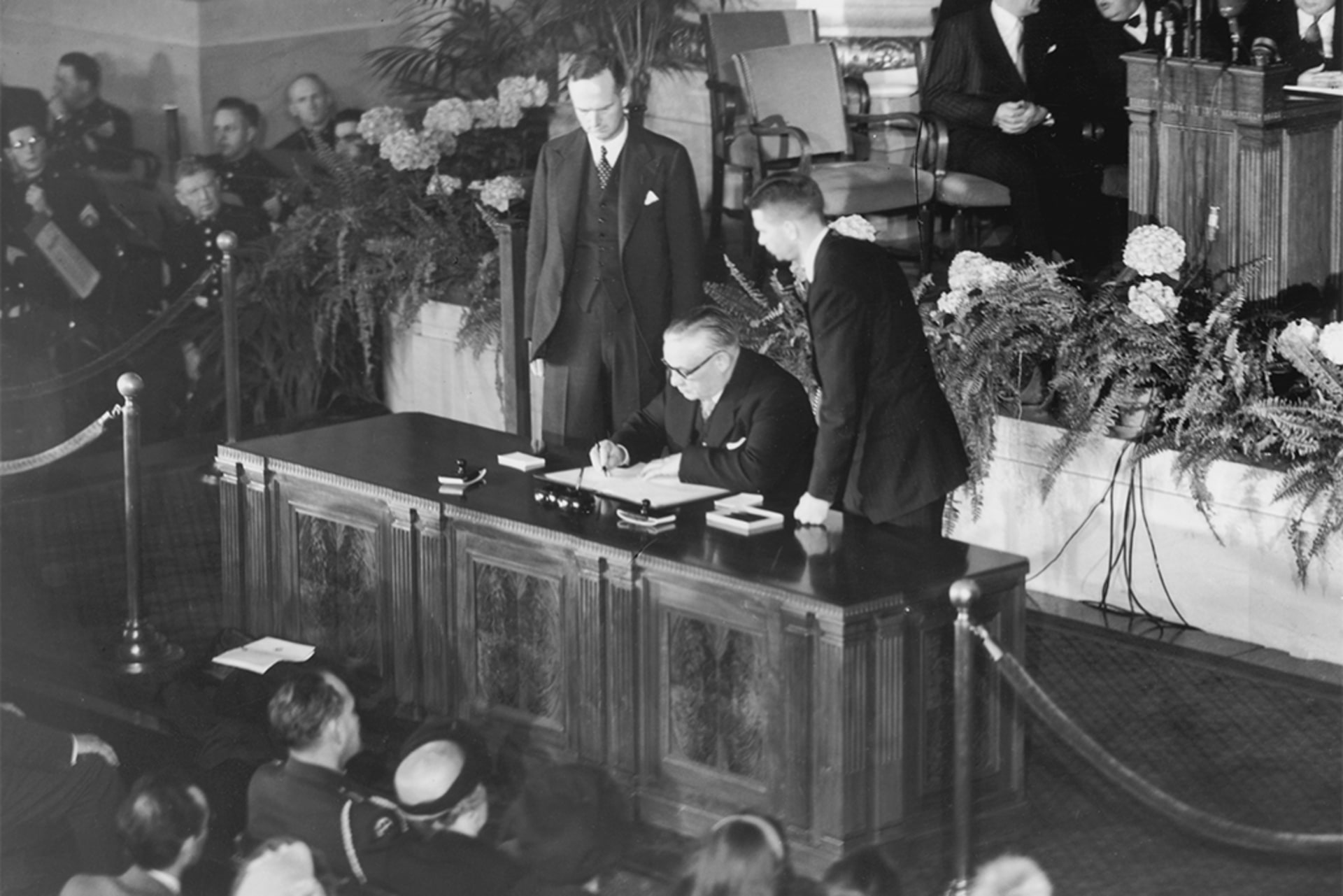 British Foreign Secretary Ernest Bevin signs the North Atlantic Treaty in Washington while Sir Oliver Franks, the British ambassador to the United States, watches on April 4, 1949.