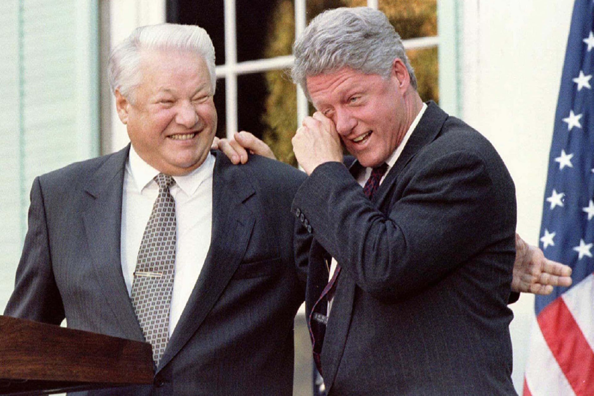 U.S. President Bill Clinton wipes away tears of laughter as he leans on Russian President Boris Yeltsin after a remark by Yeltsin during a joint press conference following their talks in Hyde Park, New York, on October 23, 1995.