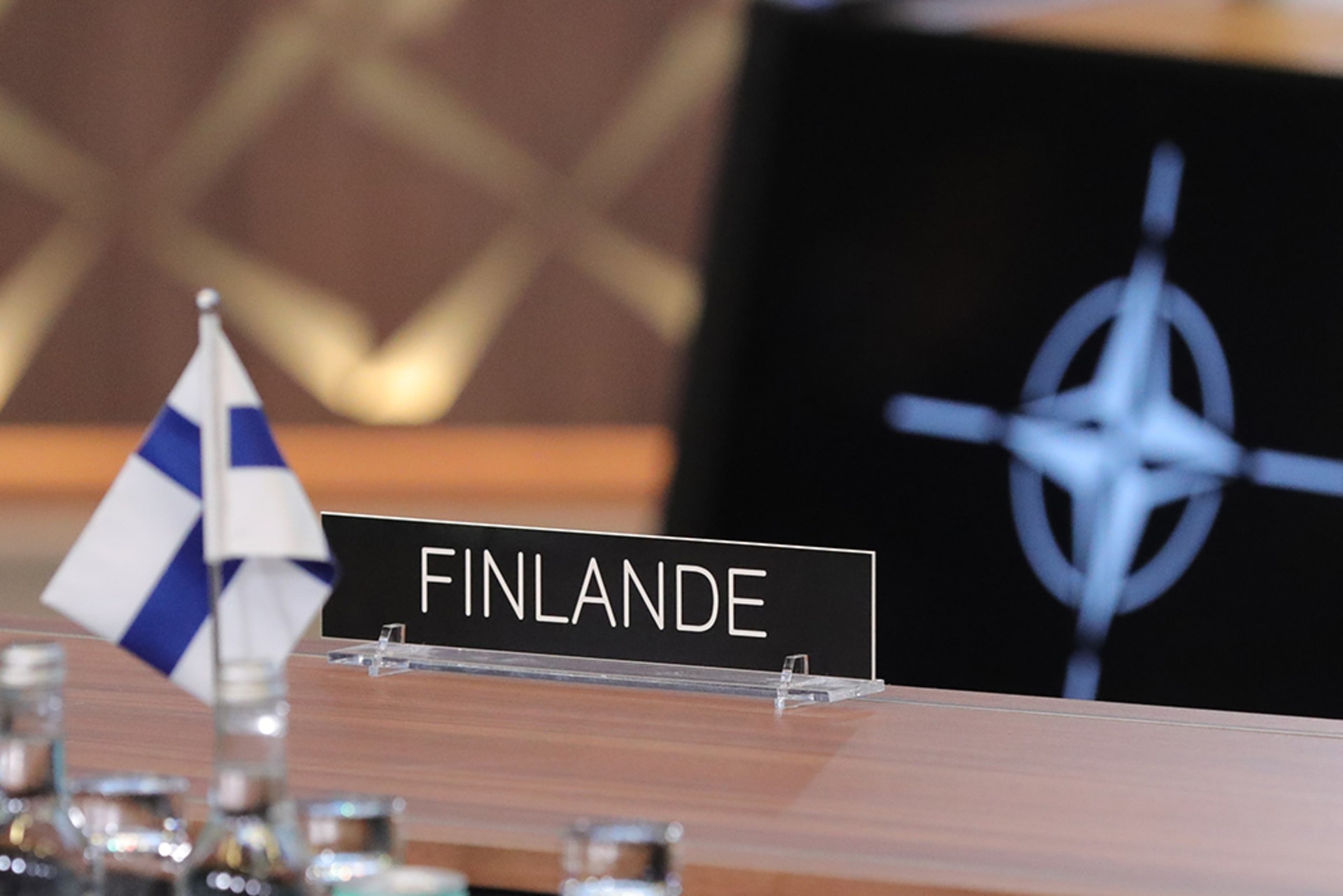 The national flag of Finland and emblem of NATO are seen at the NATO headquarters in Brussels, Belgium, April 4, 2023.