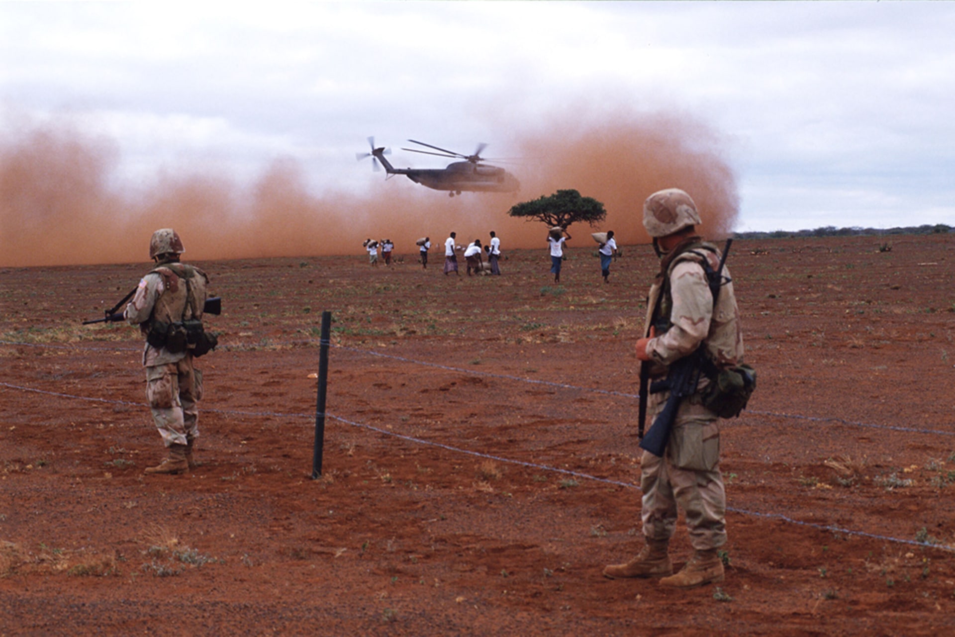 U.S. marines stand guard during a food delivery in Somalia on January 15, 1993.