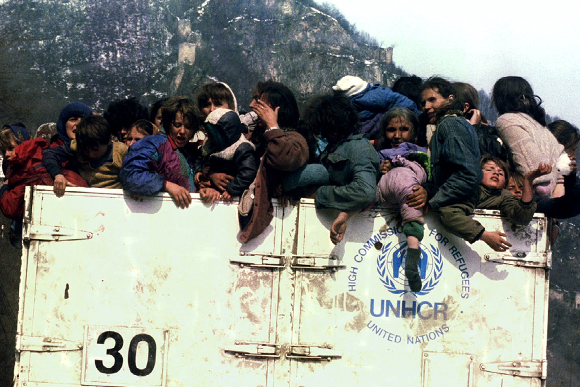 Muslim refugees are evacuated from Srebrenica, Bosnia and Herzegovina, in an overloaded UNHCR truck on March 31, 1993.