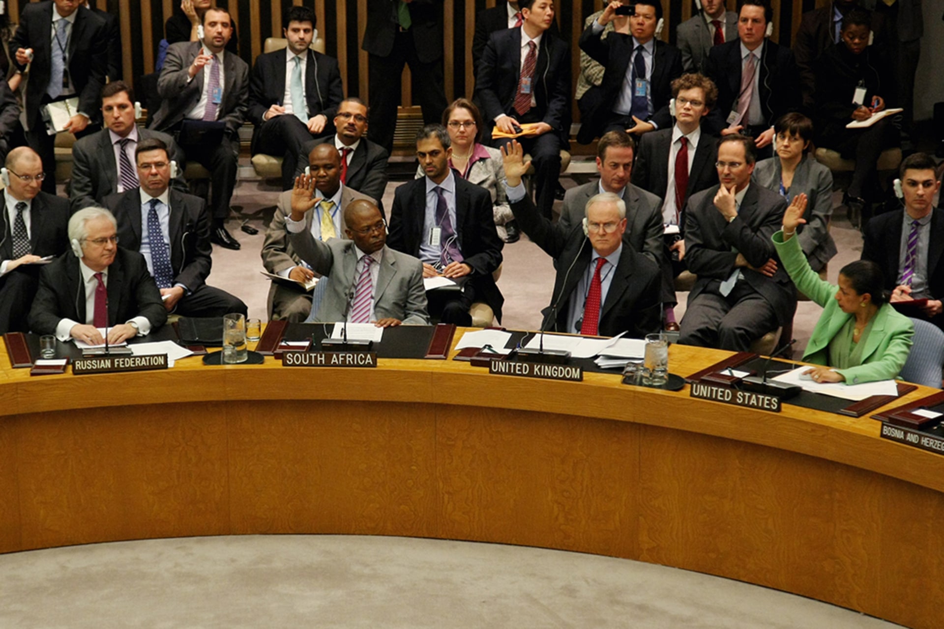 Members of the UN Security Council vote in favor of the resolution to impose a no-fly zone on Libya at the UN headquarters in New York on March 17, 2011. The Russian representative (left) abstained from the vote.