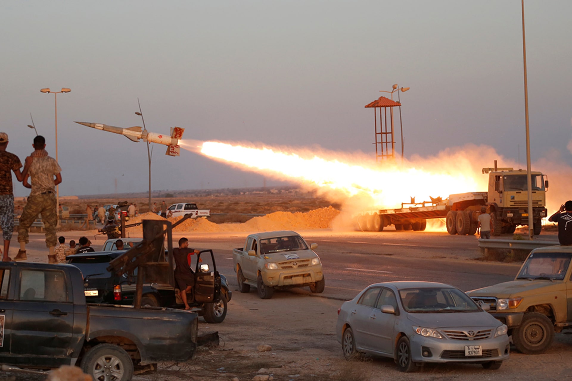 Libyan forces allied with the UN-backed government fire a rocket at Islamic State forces in Sirte, Libya, as fighting continues years after the NATO intervention, on August 4, 2016.