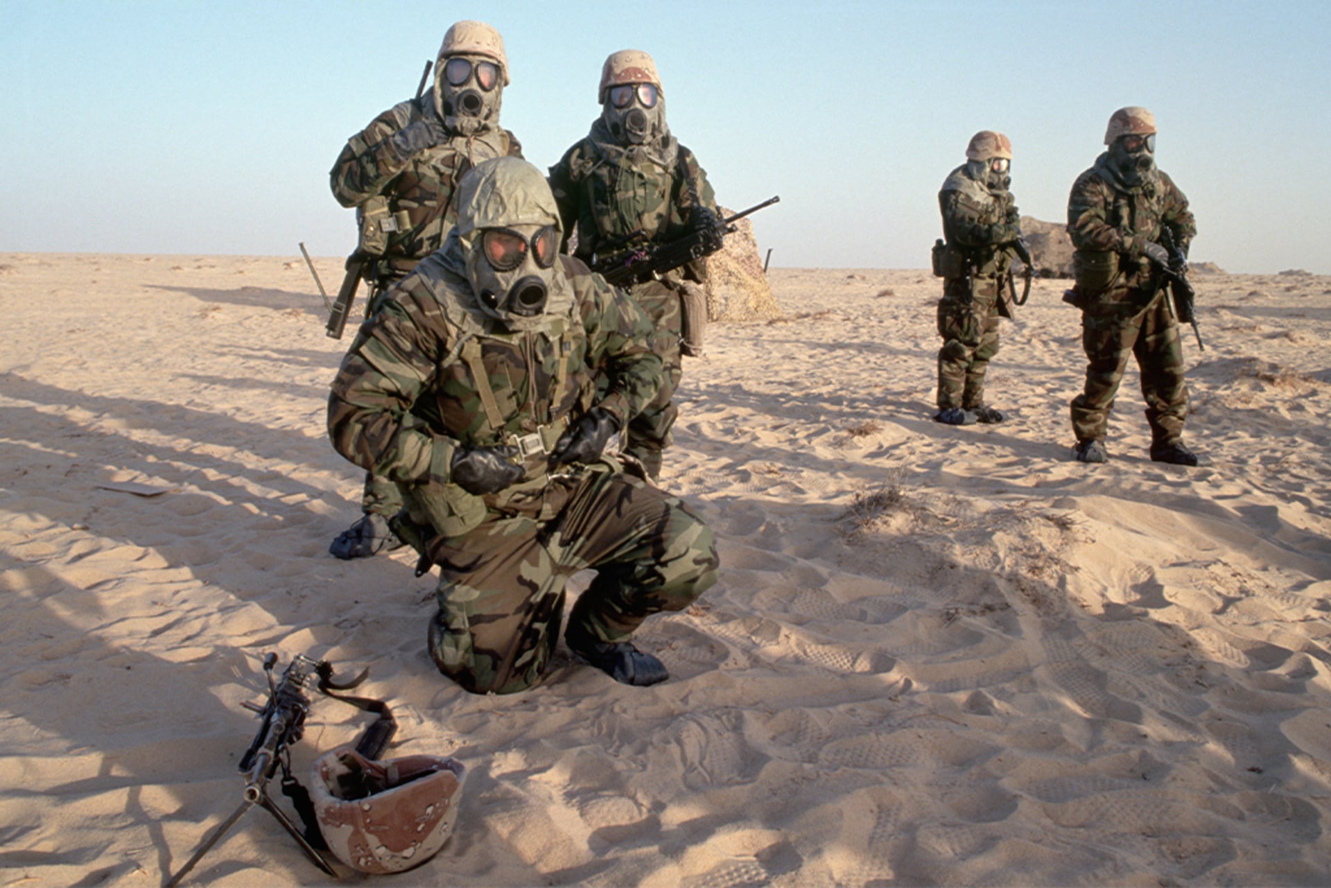 American soldiers, part of a U.S.-led coalition preparing to liberate Iraqi-occupied Kuwait, wear gas masks during a chemical warfare exercise in Saudi Arabia, in December 1990.