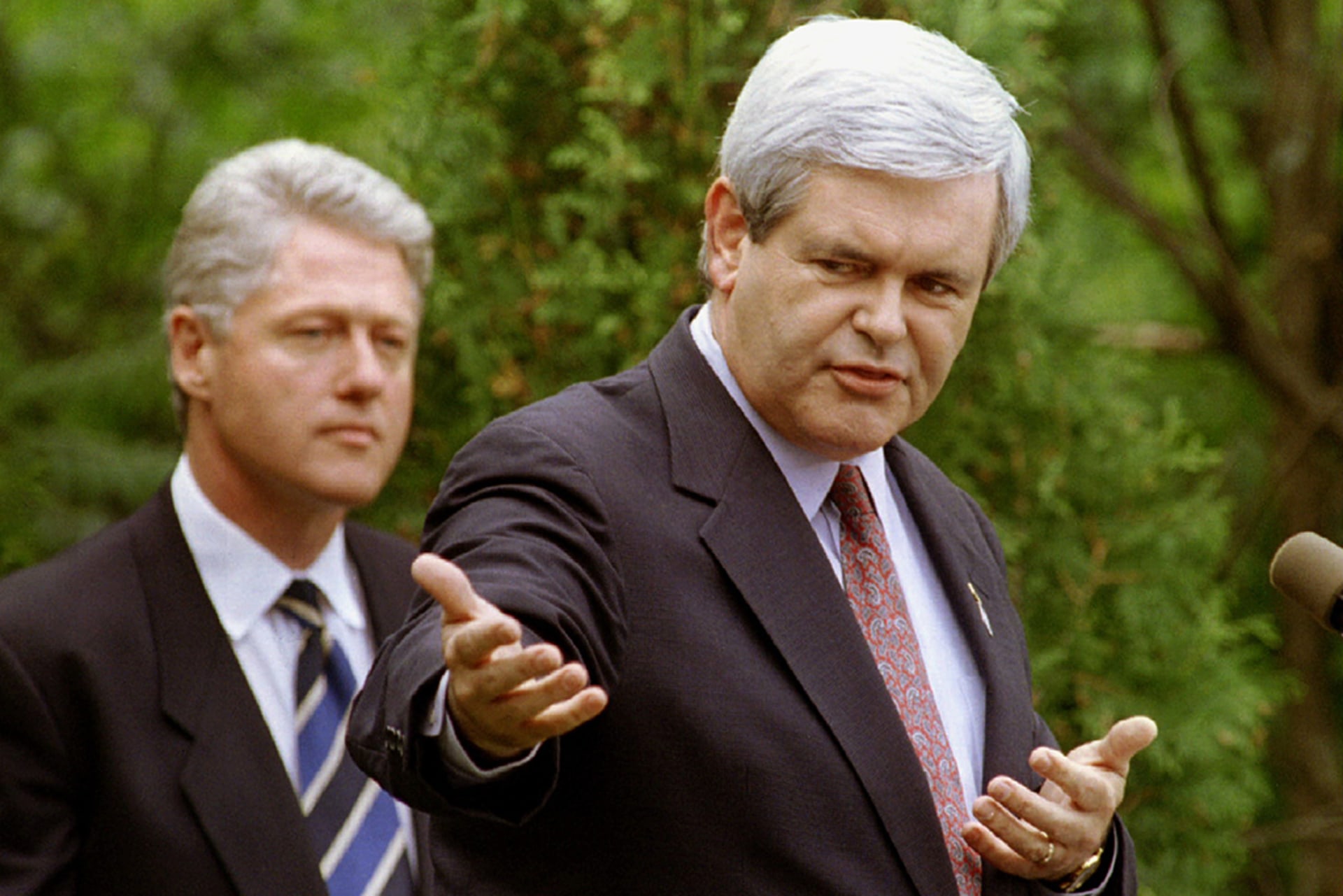 House Speaker Newt Gingrich makes opening remarks as President Bill Clinton looks on at a question and answer meeting between the two leaders in Claremont, New Hampshire, on June 11, 1995.