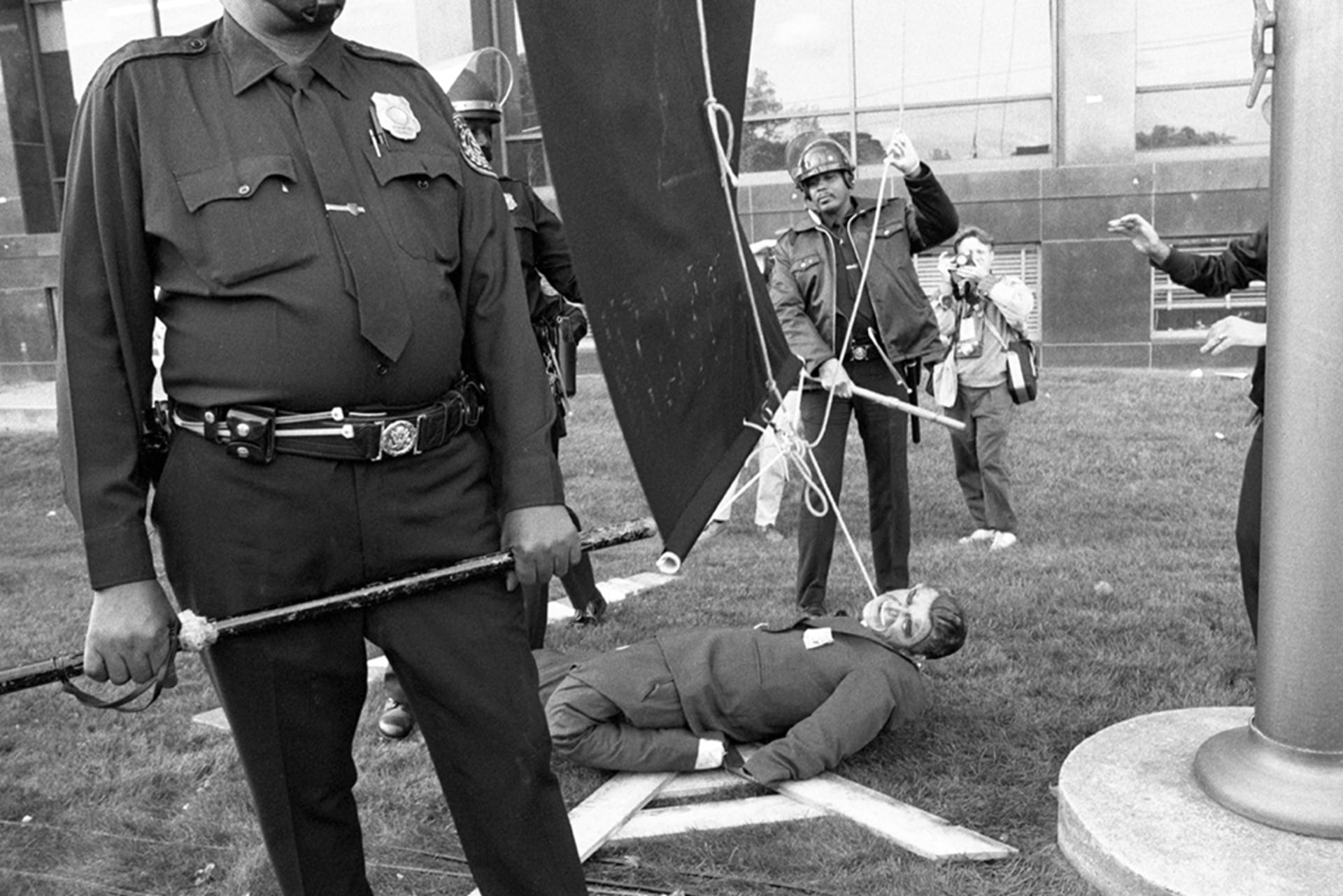 AIDS activists prepare to hang an effigy of President Ronald Reagan at the headquarters of the Food and Drug Administration in Rockville, Maryland, on October 11, 1988.