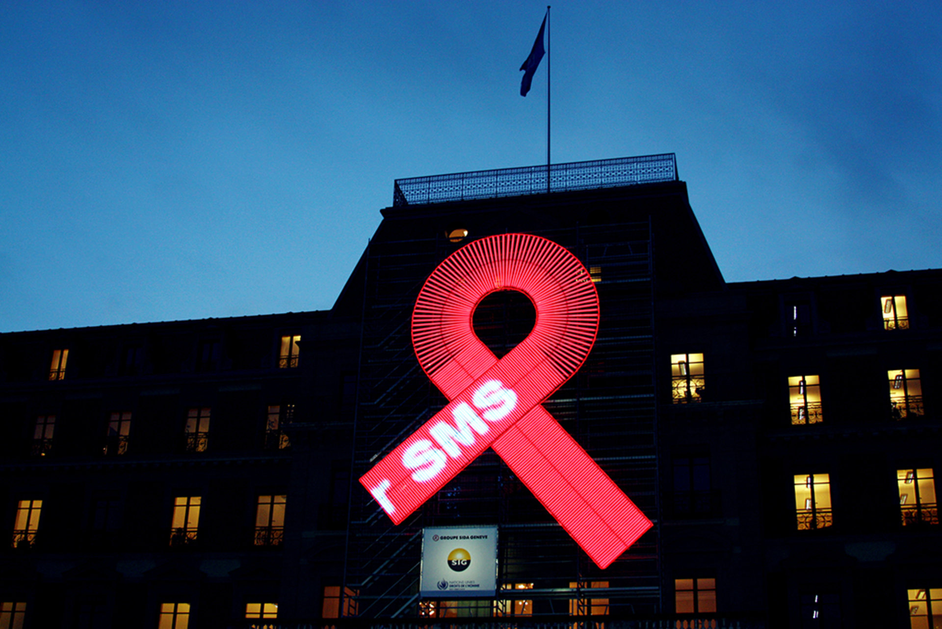 A red ribbon, a symbol of solidarity with people living with HIV/AIDS, is displayed on the façade of the UN Human Rights Office's headquarters in Geneva, Switzerland, on January 28, 2011.