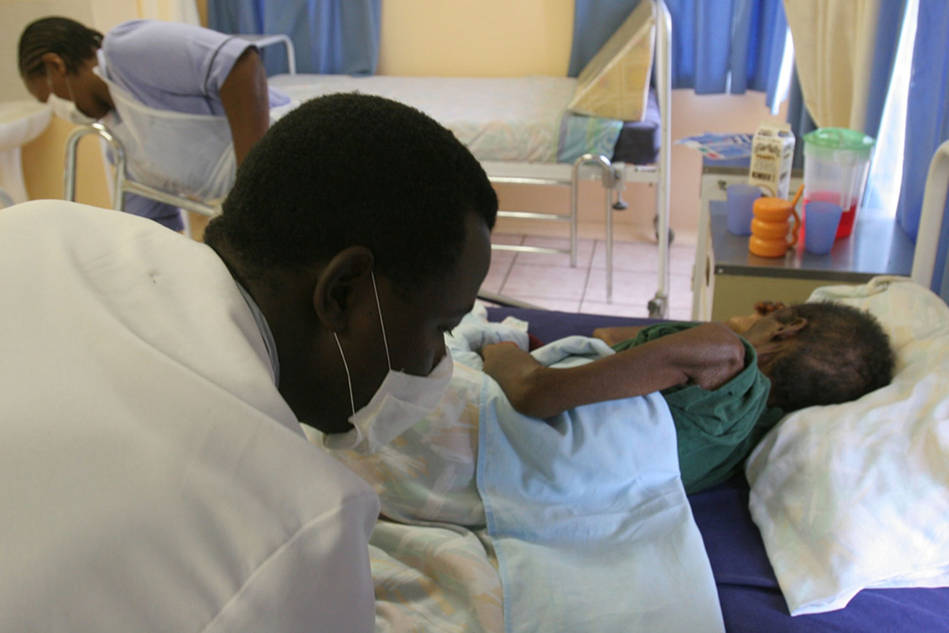 A patient is nursed at a hospice partially funded by the President's Emergency Plan for AIDS Relief (PEPFAR) in White River Junction, South Africa, on December 15, 2008.