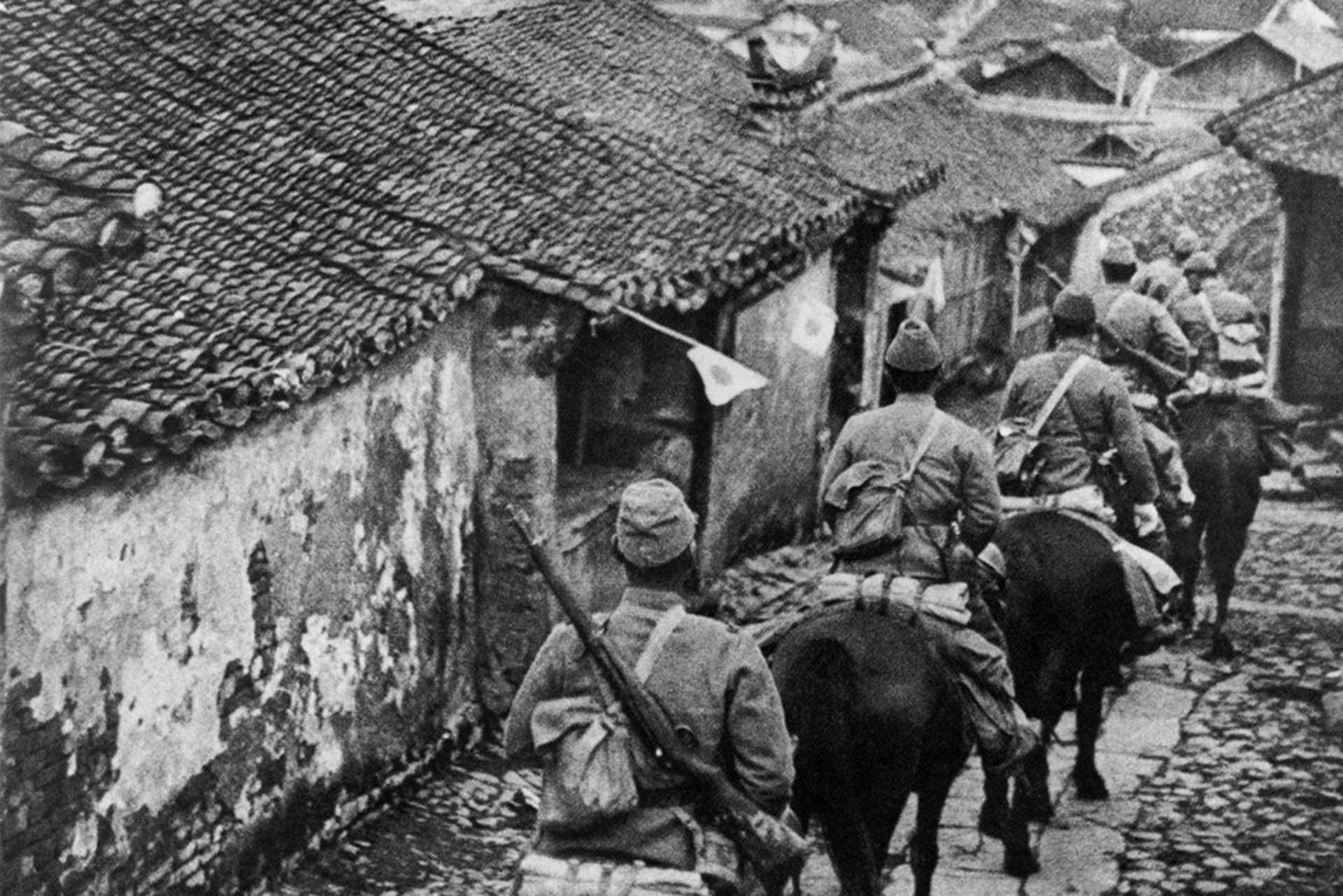 Japanese troops enter Manchuria on horseback during their 1931 invasion of the Chinese province.