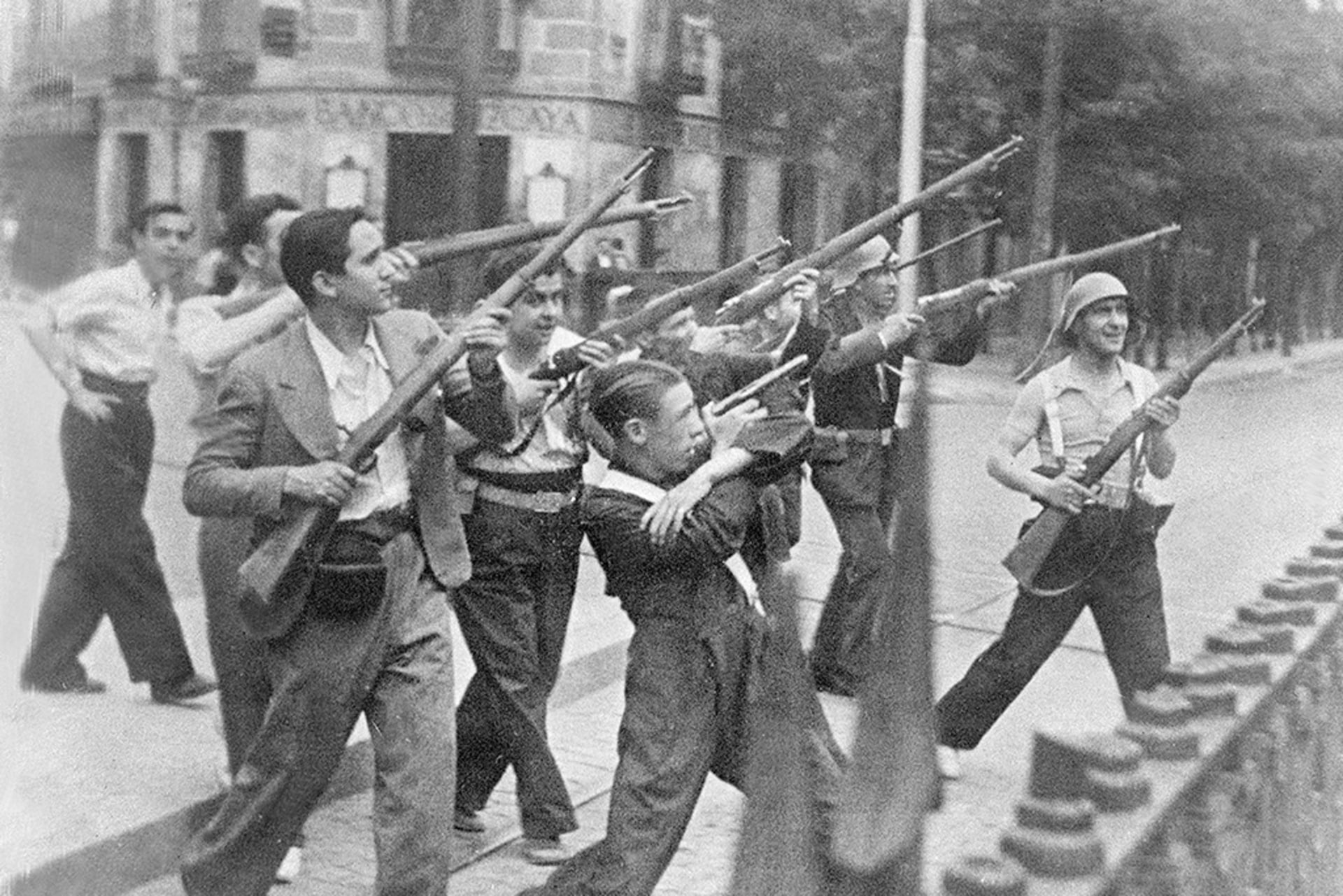 Republicans aim their rifles and fight in a street of an unidentified town against nationalist rebels in 1936 during the Spanish Civil War.