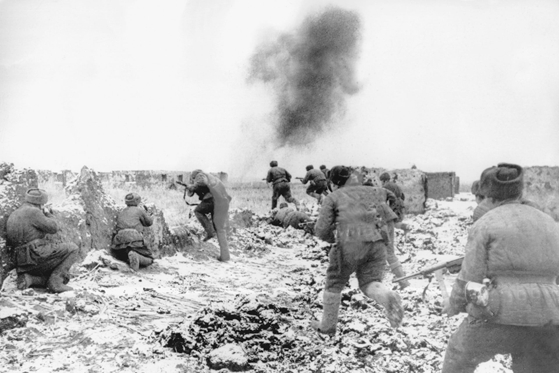 With smoke in the background, soldiers running into battle during the Battle of Stalingrad.