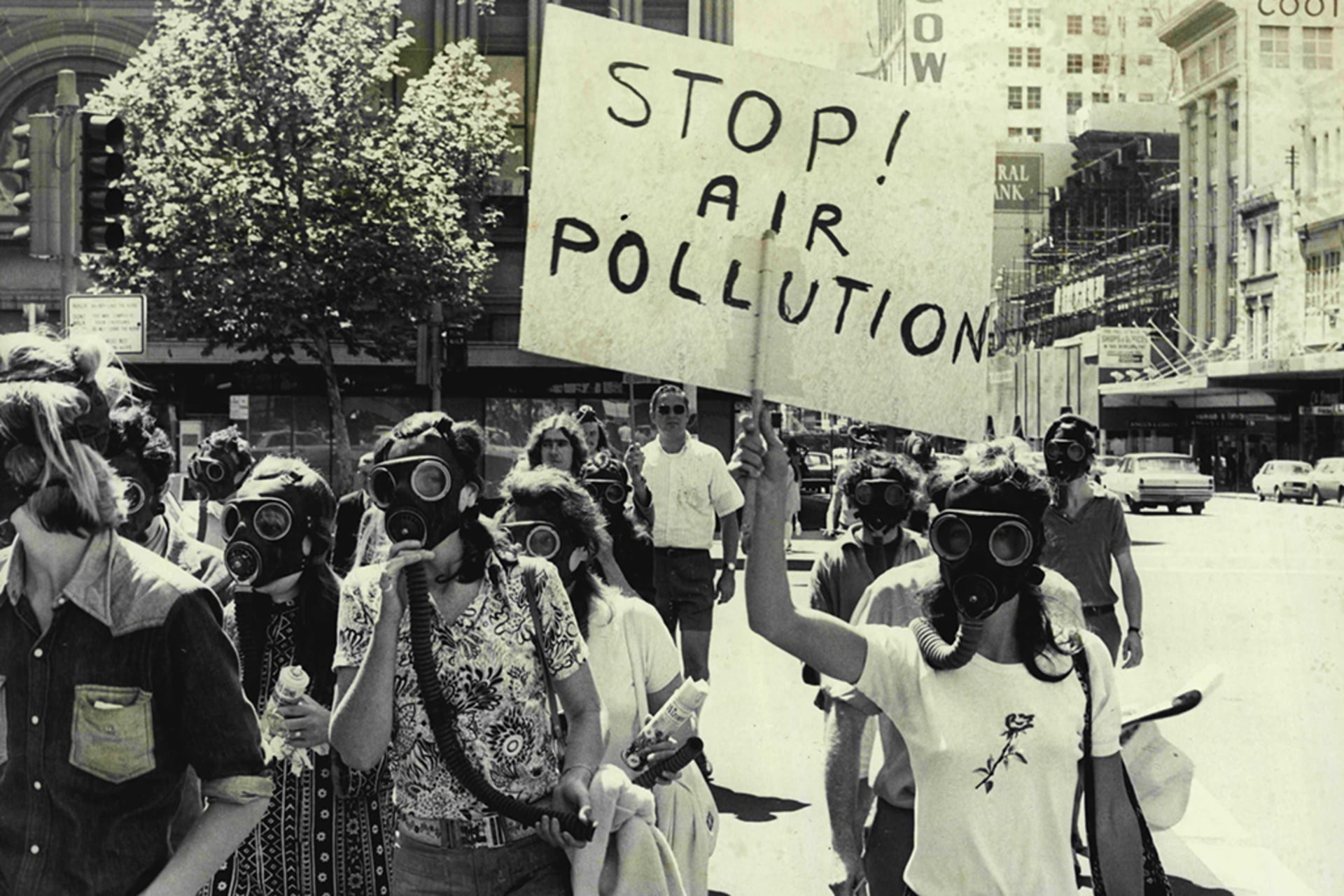 Friends of the Earth march in Sydney, Australia on October 2, 1972. People are wearing gas masks in protest and there is a sign that reads "Stop! Air pollution."