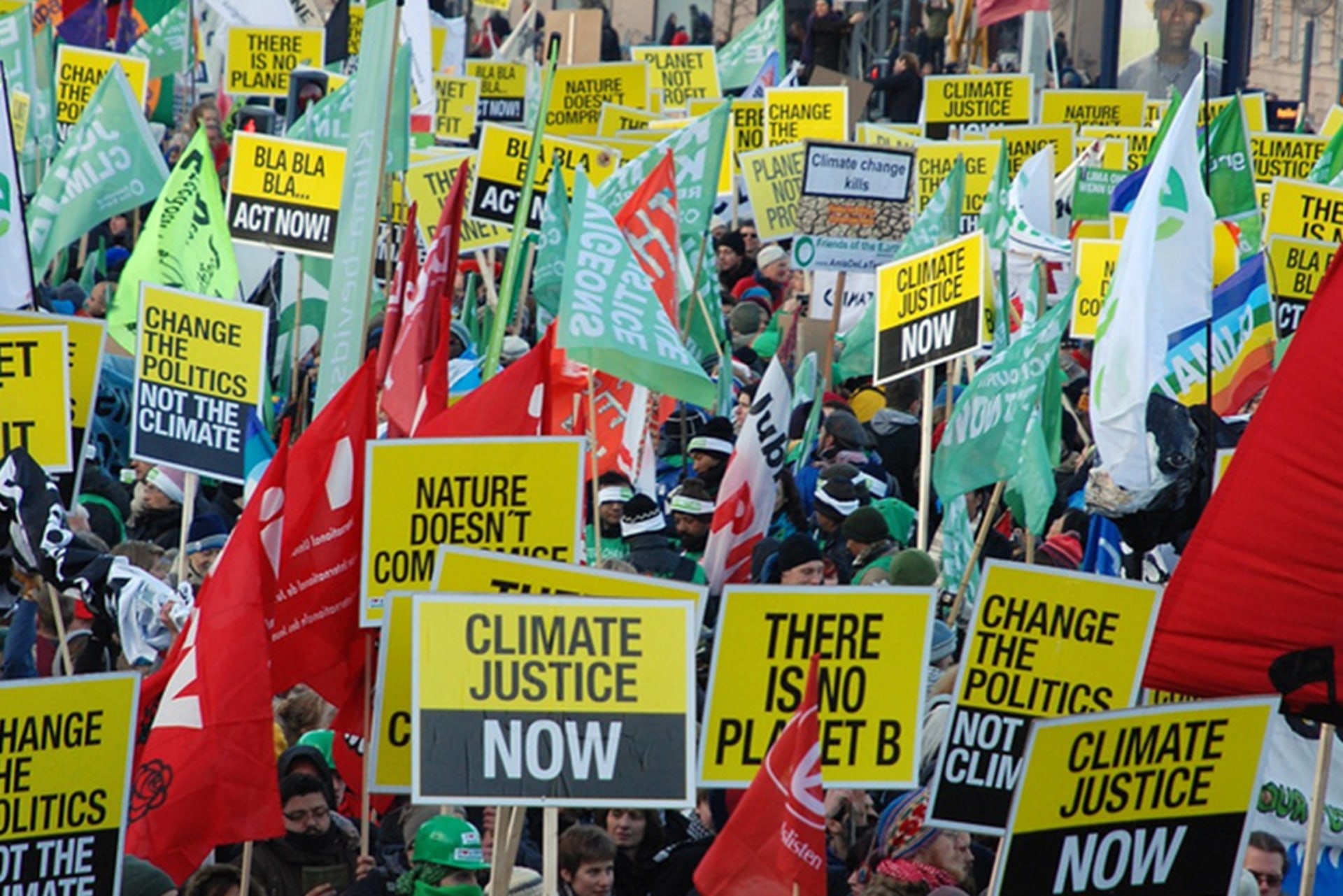 People hold signs about climate justice on the Global Action Day in Copenhagen, Denmark on December 20, 2009.