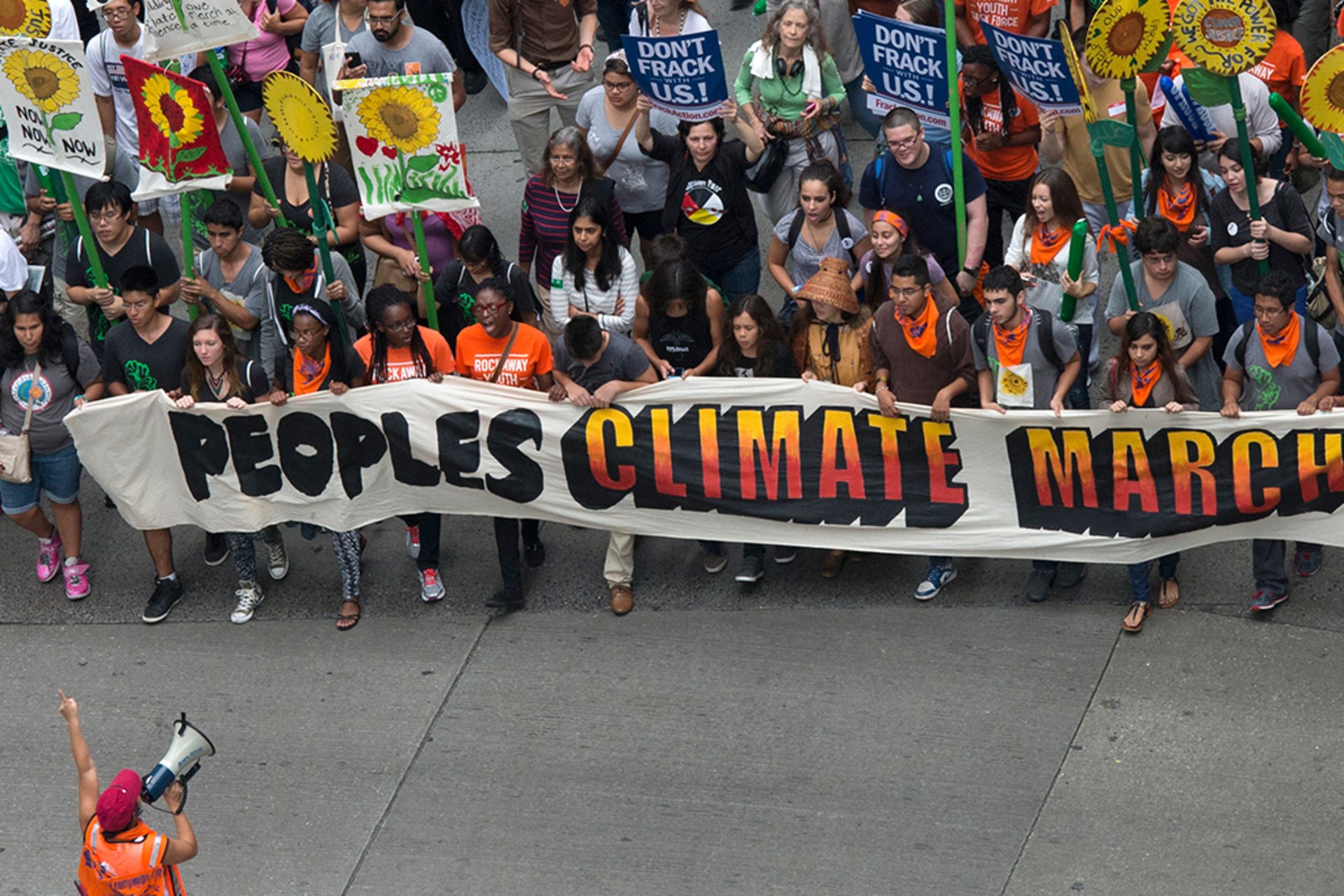 Activists hold a banner as they lead a march of tens of thousands during the People's Climate March through Midtown, New York September 21, 2014. The banner reads, "Peoples Climate March."