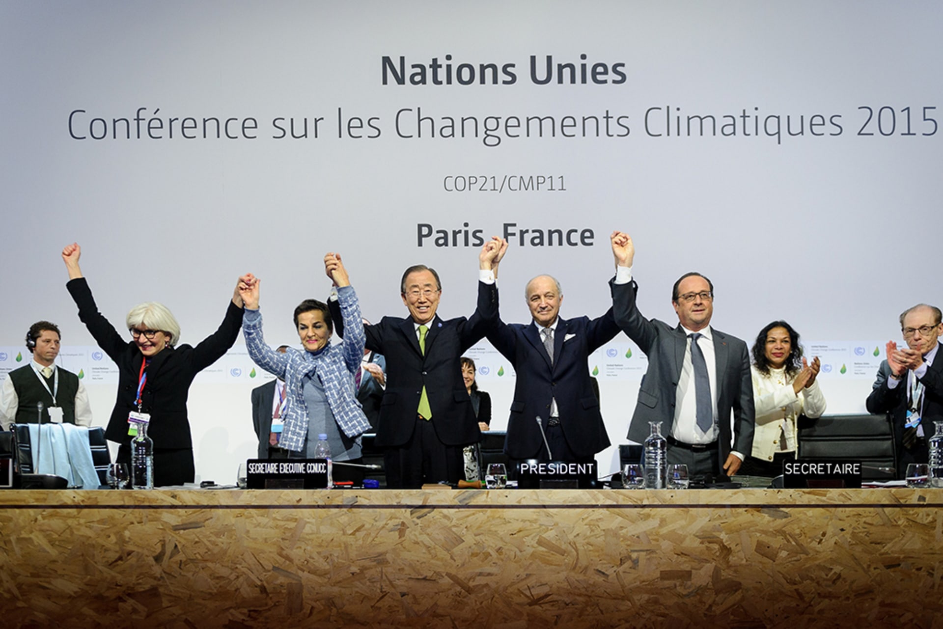 United Nations leaders raise and join their hands in triumph after adopting the historic global warming pact known as the Paris Agreement at the 21st Conference of Parties (COP) in Le Bourget, north of Paris, on December 12, 2015.