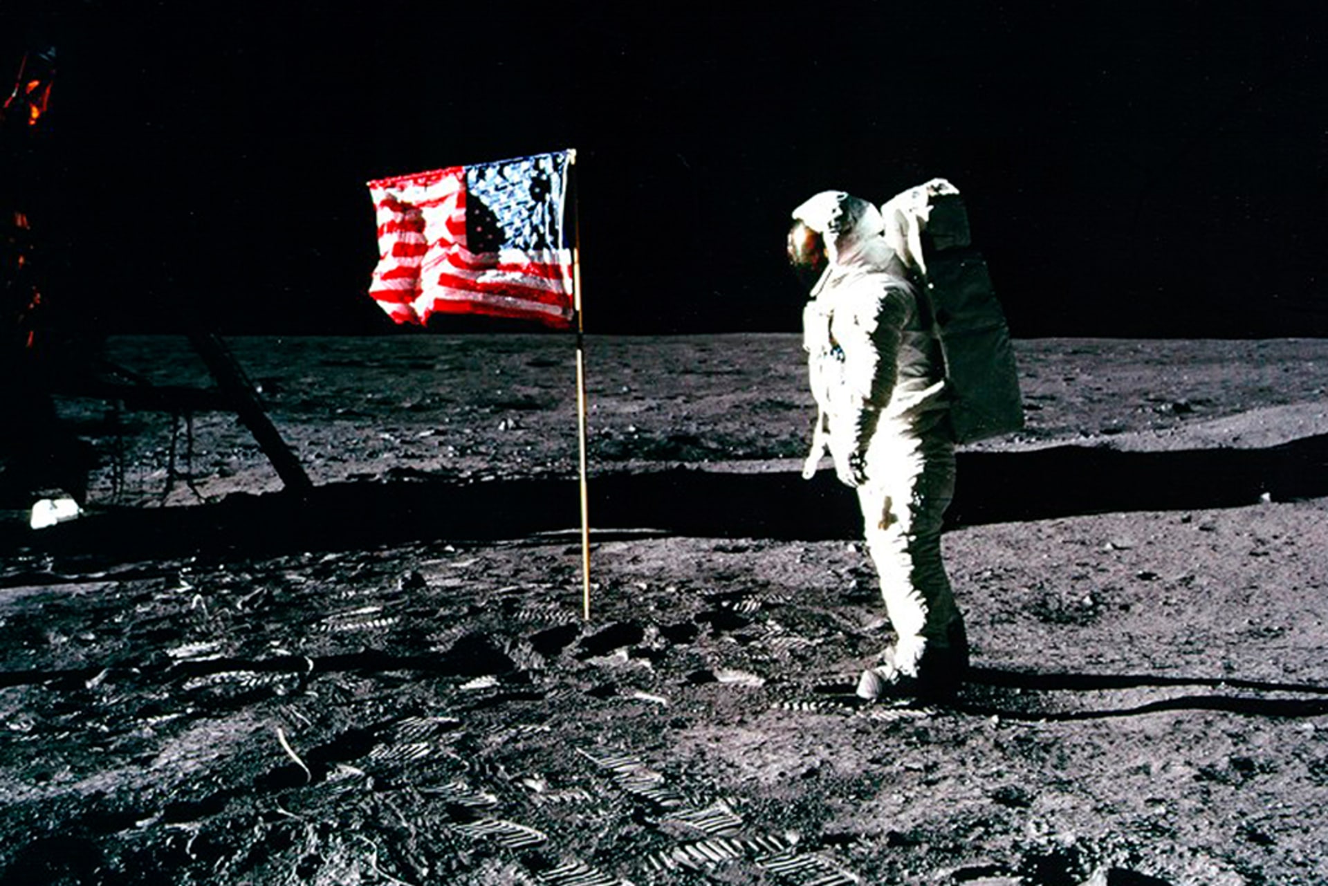 U.S. astronaut Buzz Aldrin salutes the American flag on the surface of the Moon.