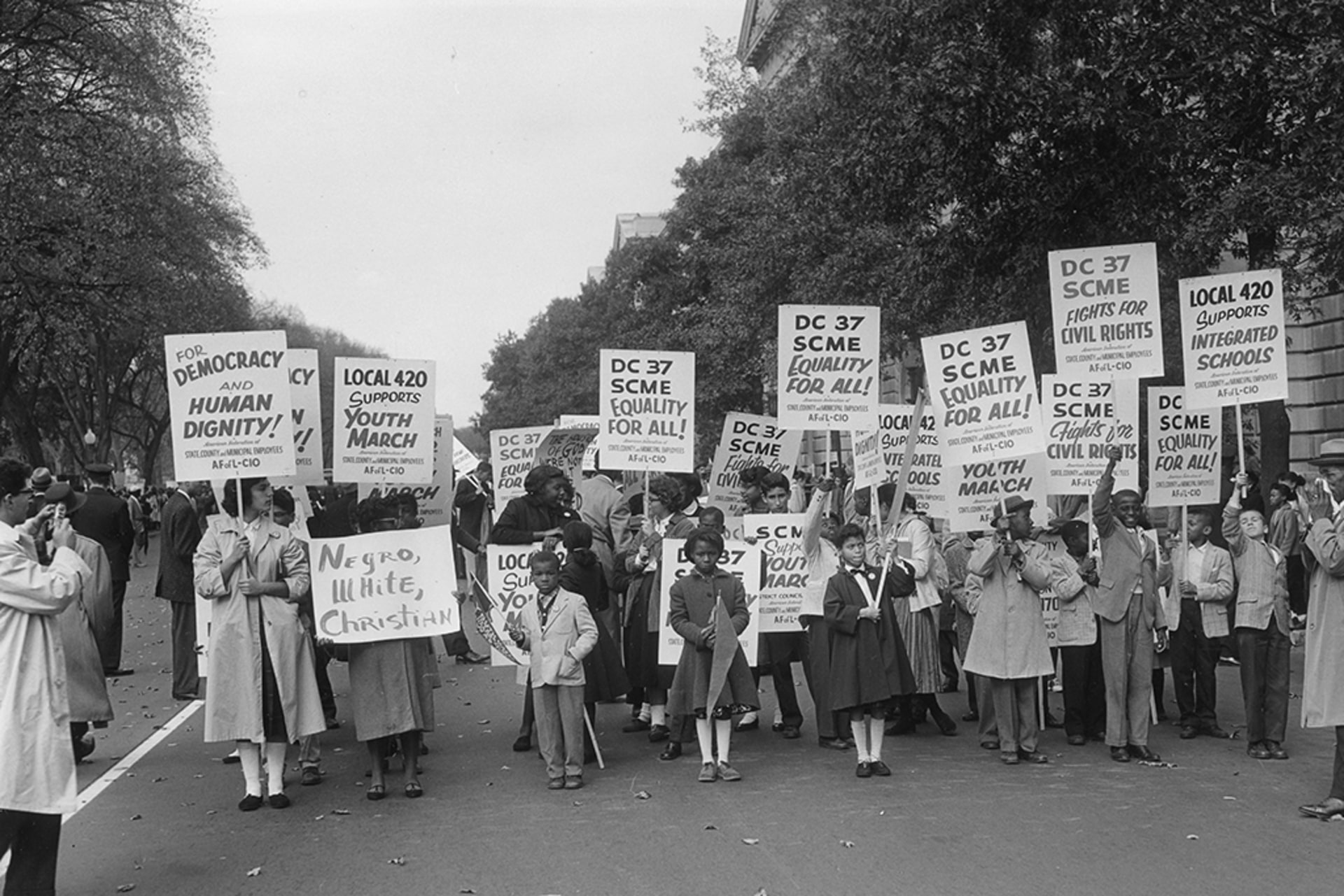Demonstrators hold various signs at the Lincoln Memorial Youth March for Integrated Schools.
