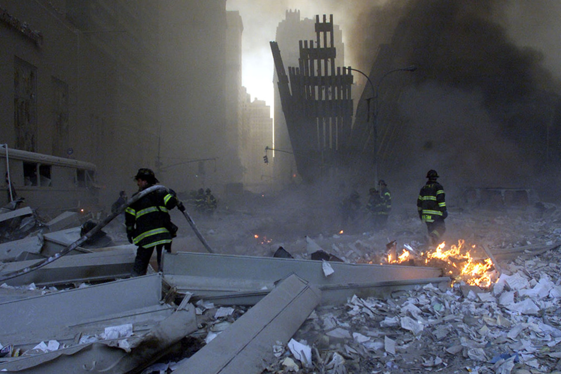 Firemen work in the rubble around the World Trade Center after both towers collapsed in New York on September 11, 2001.