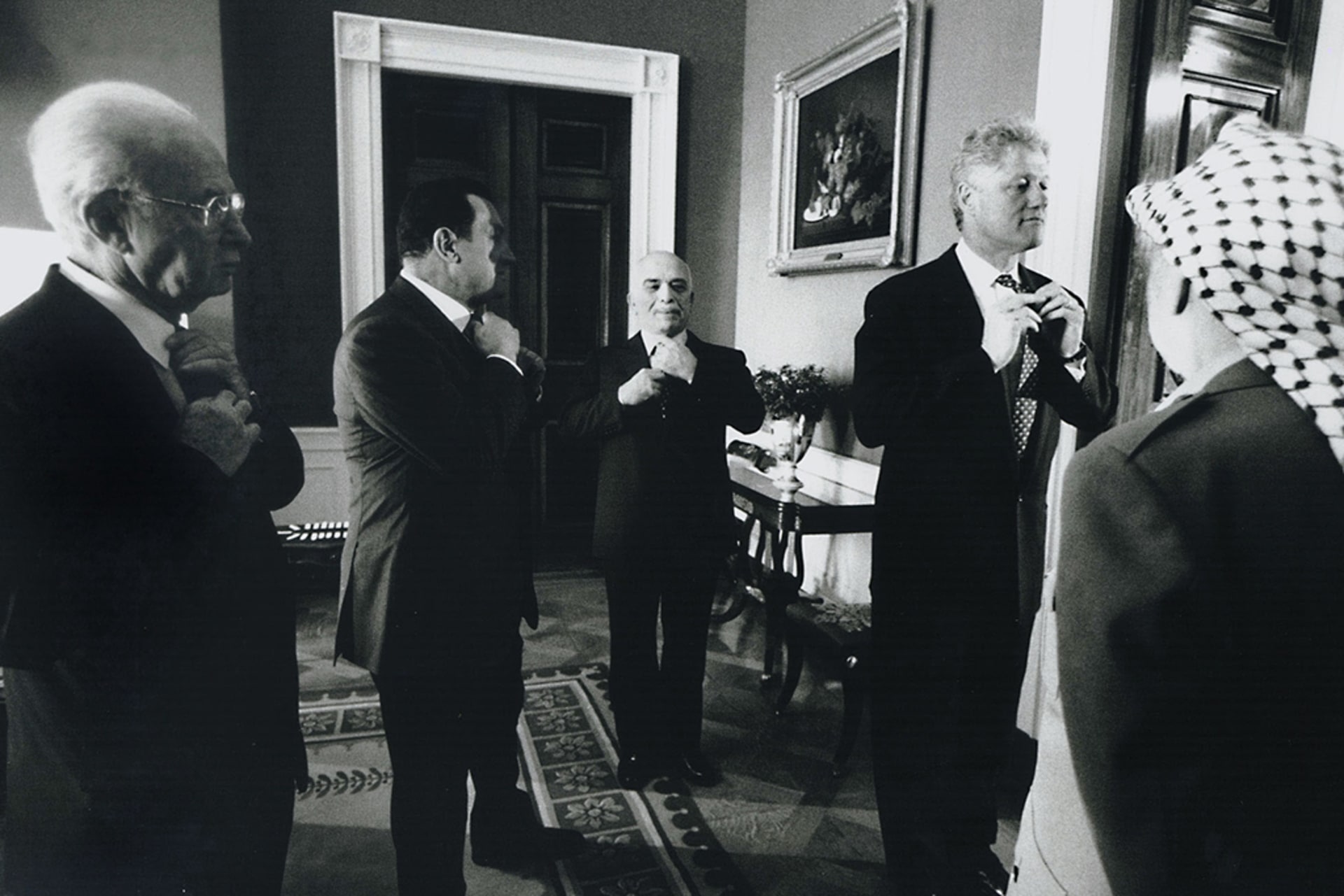 Former United States President Bill Clinton stands next to the Israeli Prime Minister Yitzhak Rabin. Both leaders adjust their ties as they prepare to exit the White House on the occasion of the signing of the Israeli-Palestinian Interim Agreement.