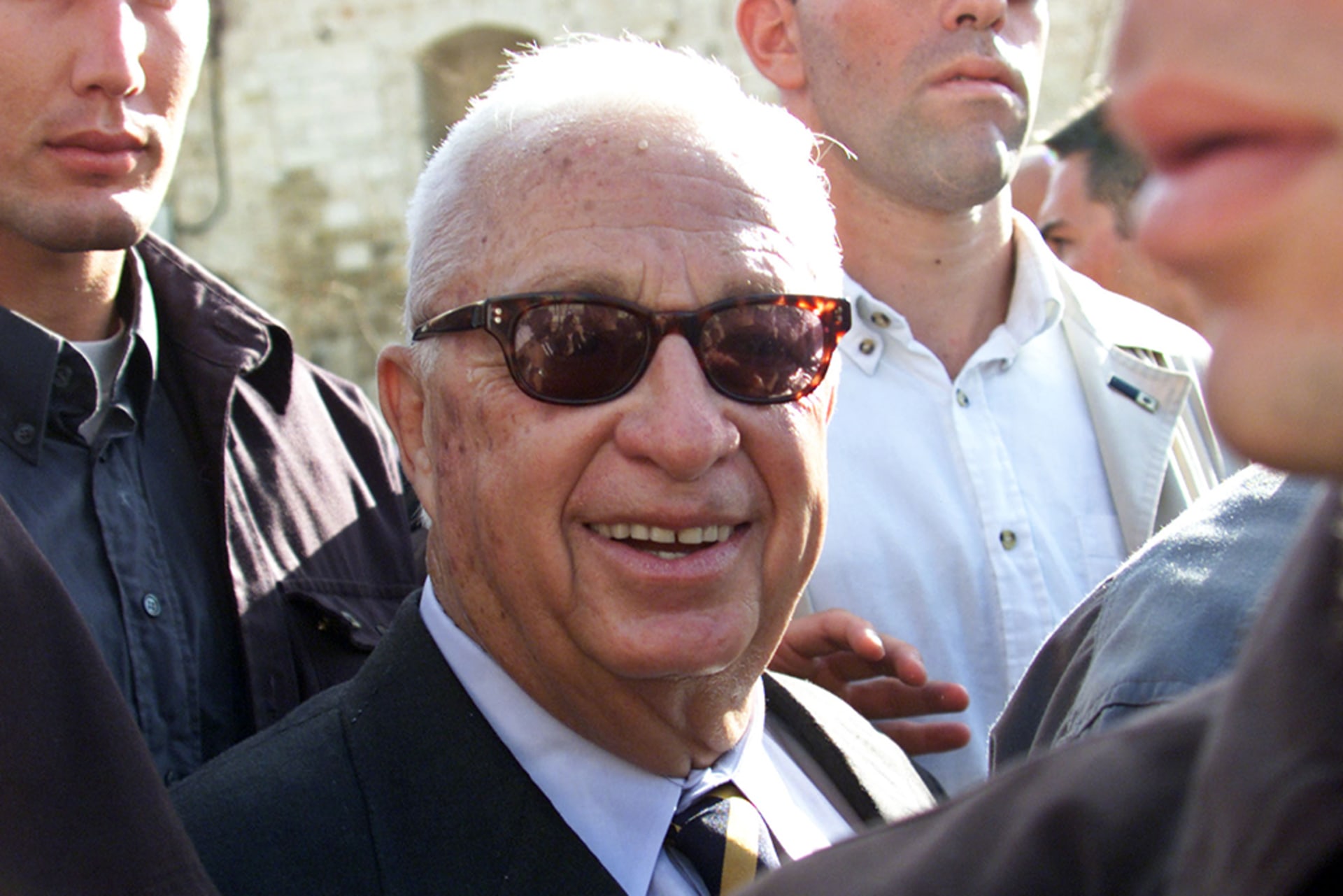 Israel's Likud Party leader Ariel Sharon smiles as he leaves the Temple Mount known to Muslims as al-Haram al-Sharif, after a controversial visit to one of Islam's holiest sites.