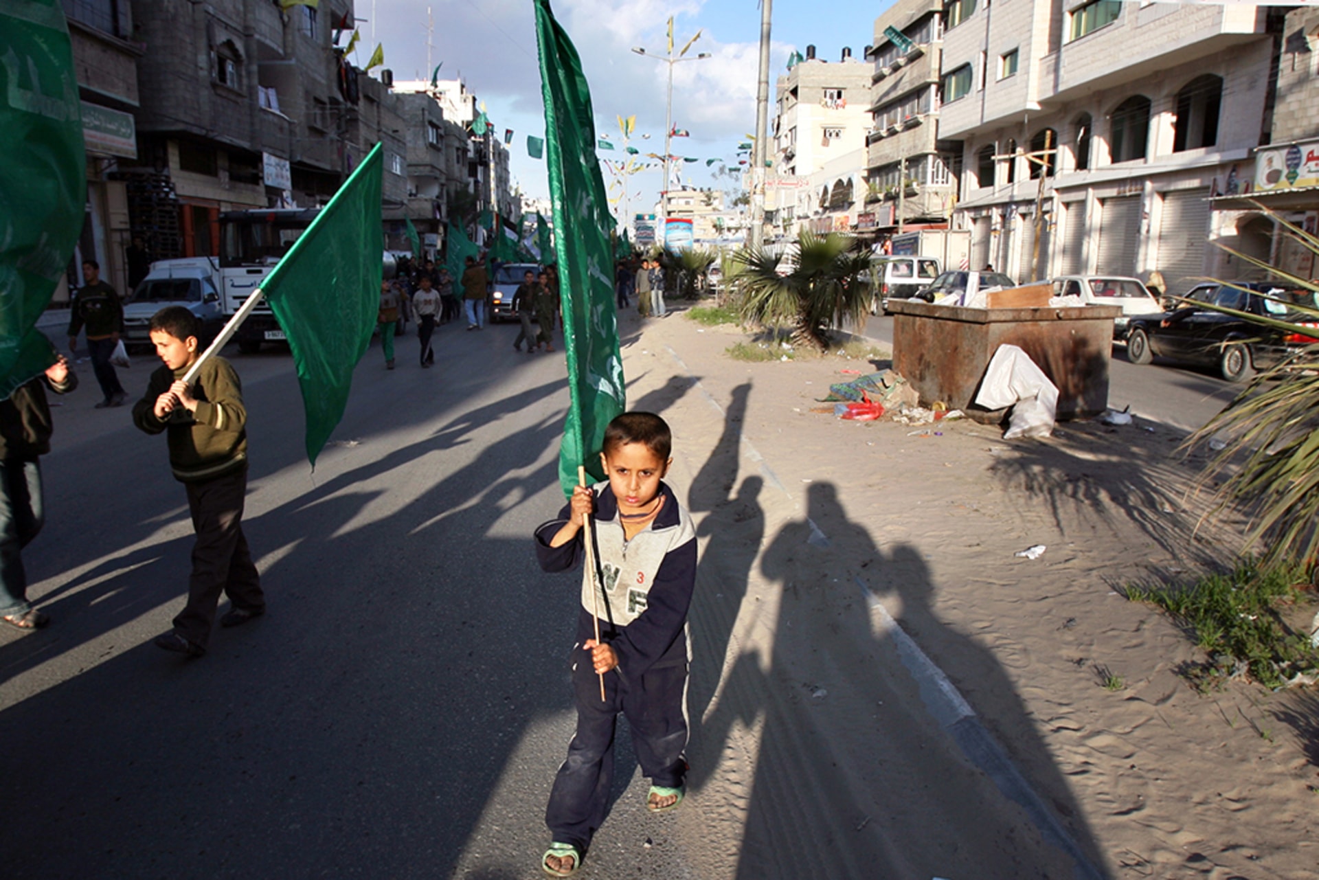 A Palestinian boy marches with a Hamas green flag as he celebrates the results of the Palestinian election in Gaza Strip.