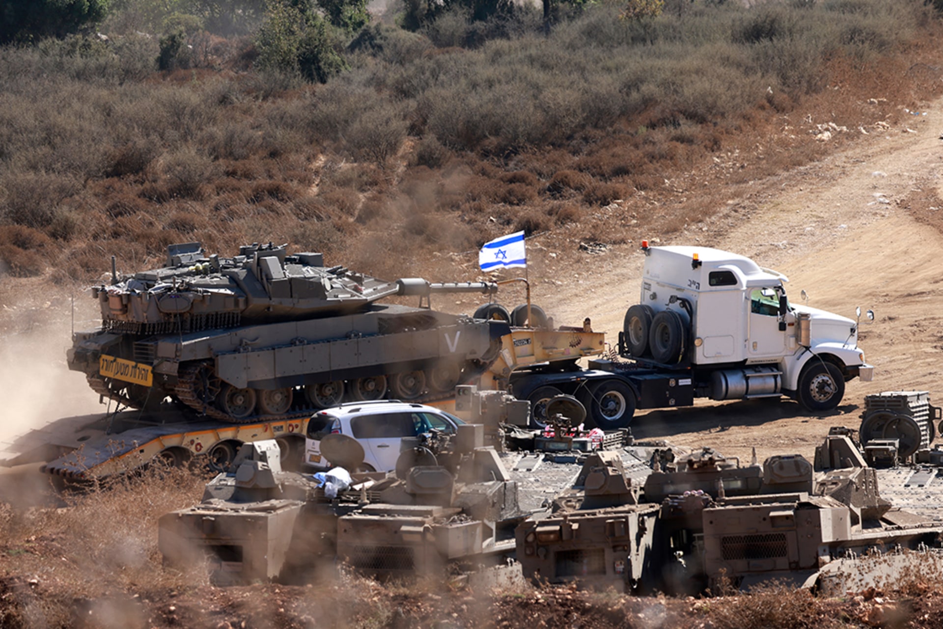 The Israeli military transports a tank to the Lebanese border in preparation for an assault.