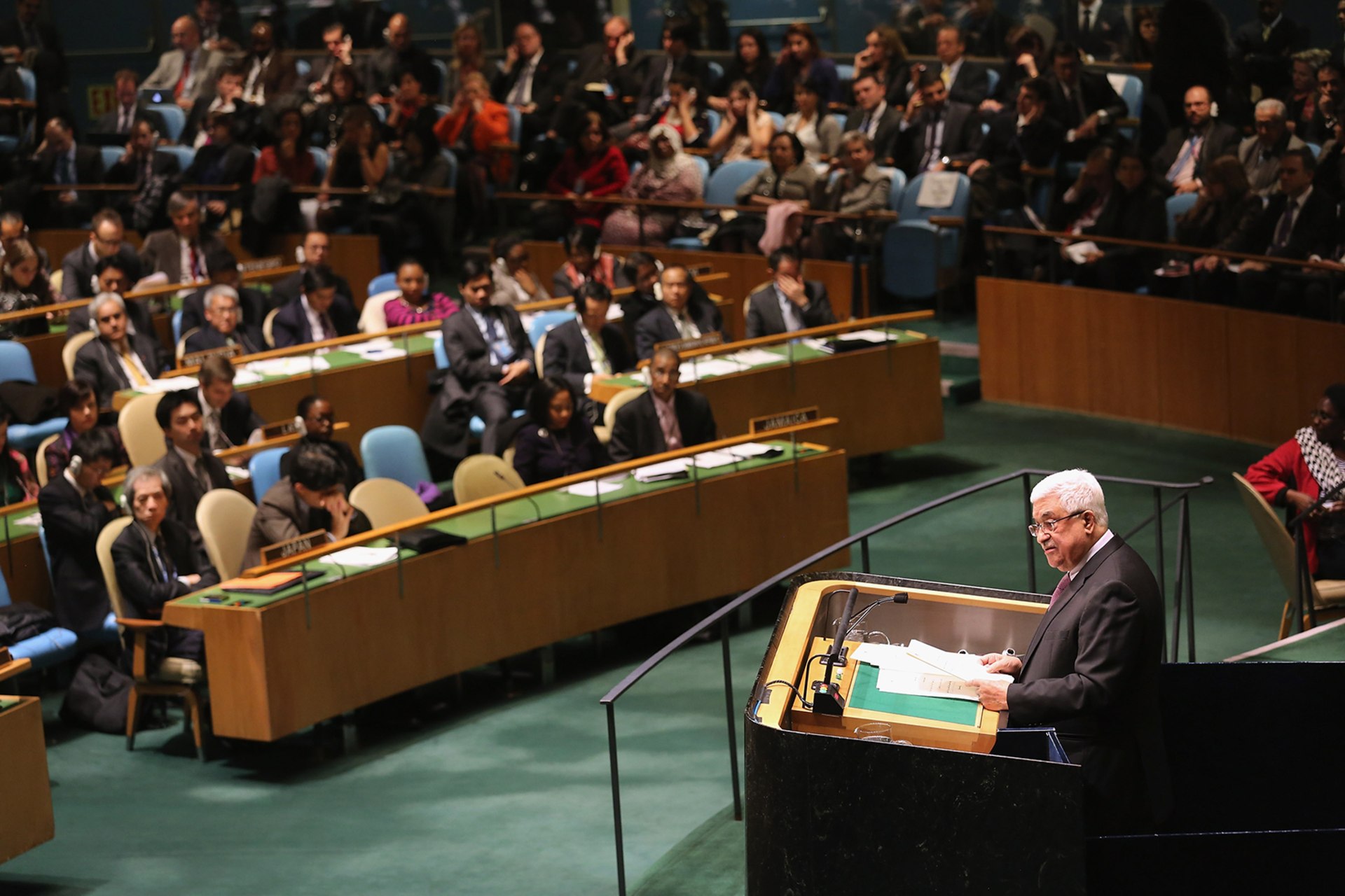 Palestinian Authority President Mahmoud Abbas stands at a podium and addresses the U.N. General Assembly.