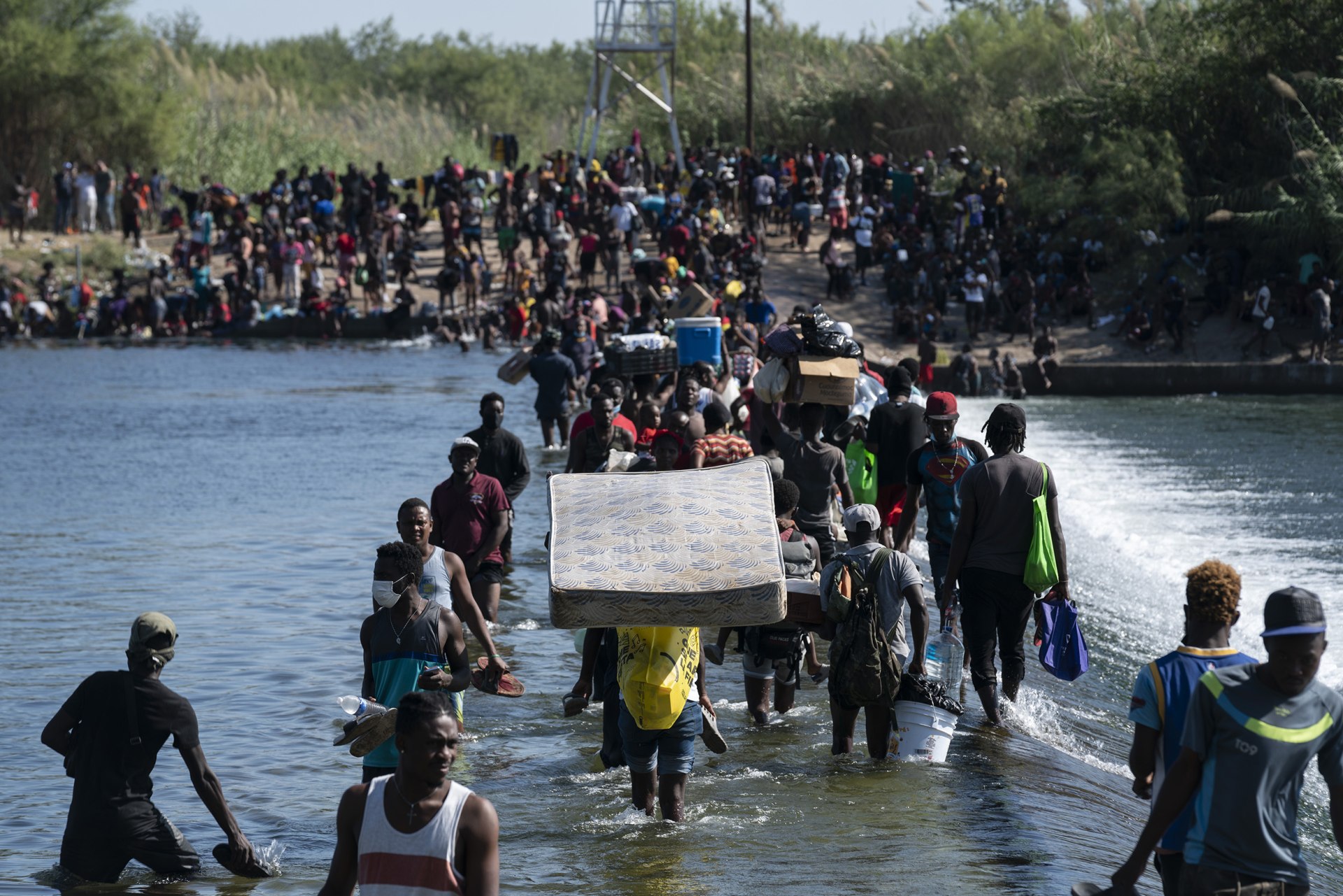 Migrants, many from Haiti, cross the Rio Grande from Ciudad Acuna, Mexico, into Del Rio, Texas, on Sept. 17, 2021. Last year, the Biden administration began granting parole to 30,000 migrants a month from Cuba, Haiti, Nicaragua and Venezuela who have fin